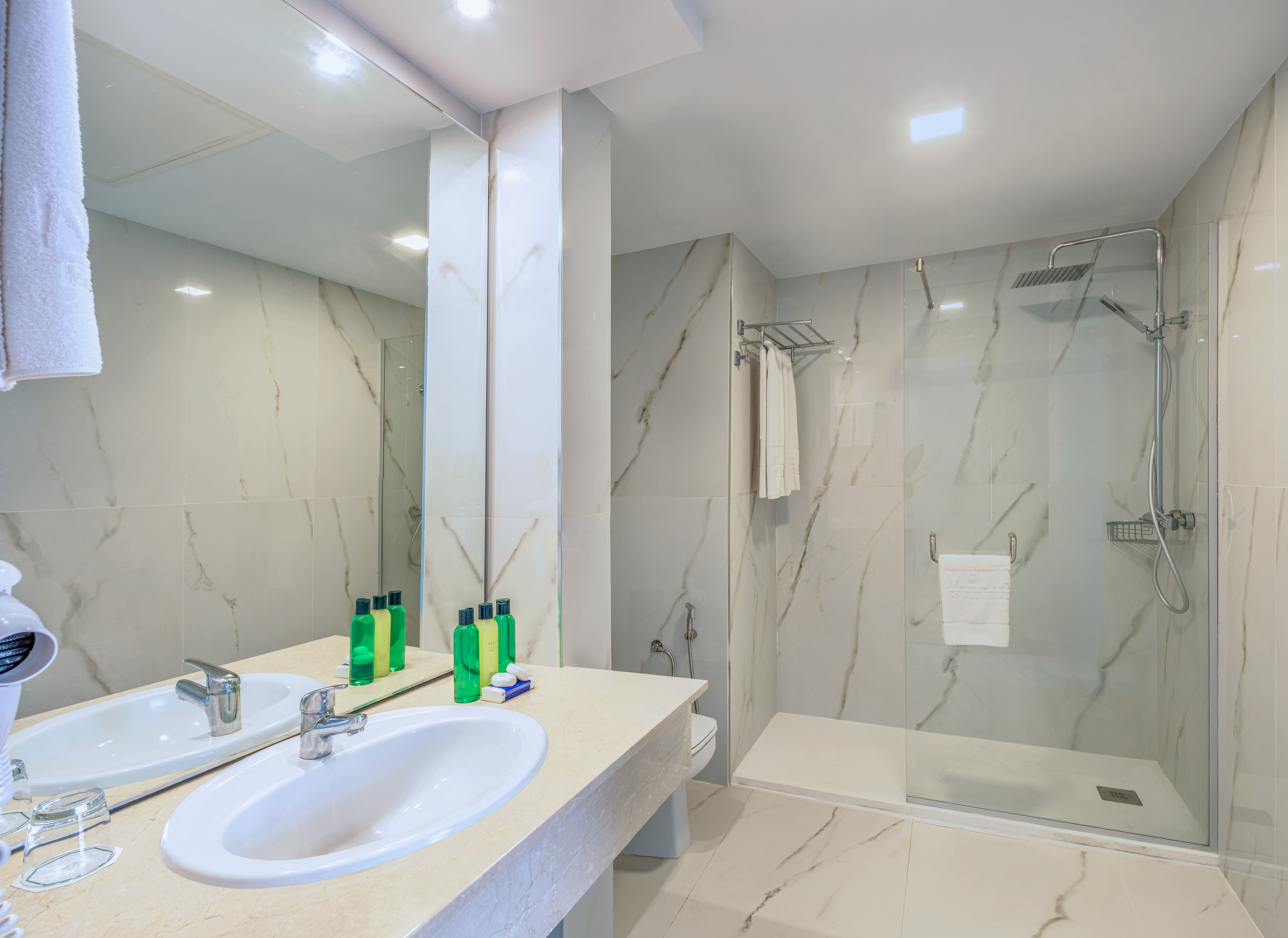 a bathroom with marble walls and a shower