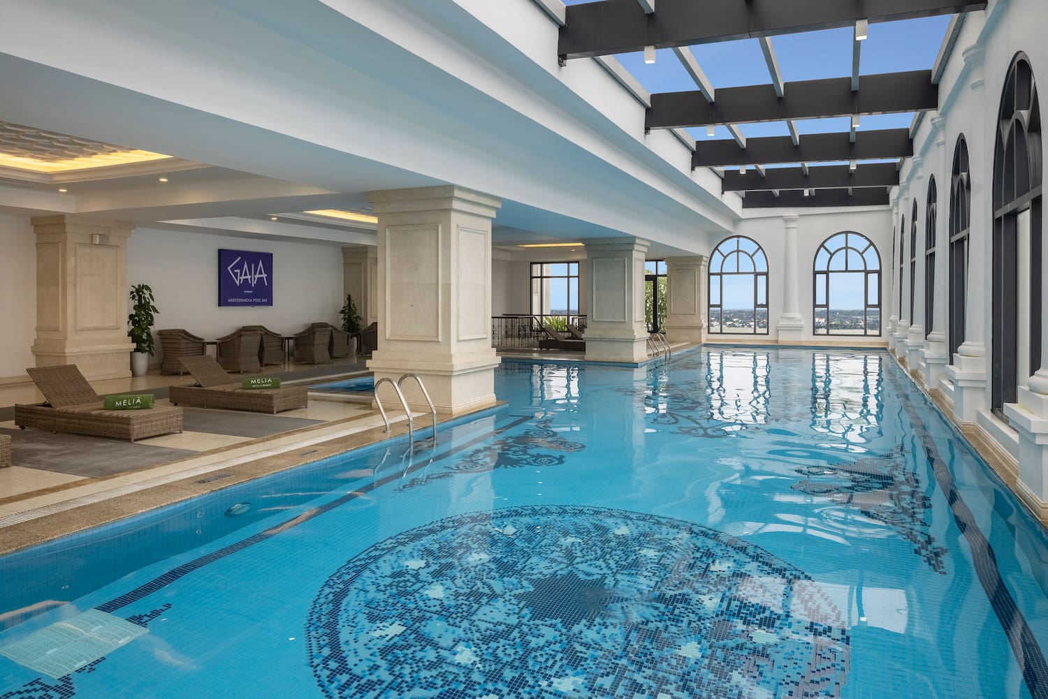 a indoor swimming pool with a large roof