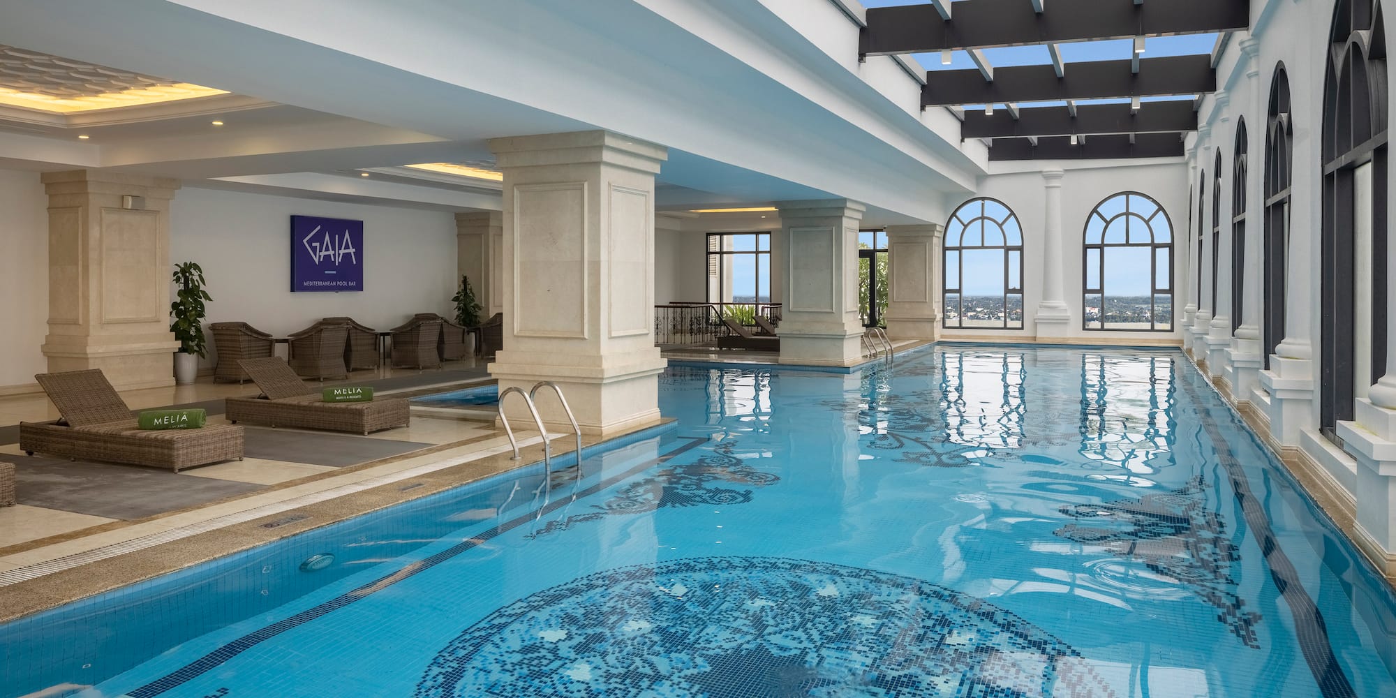 a indoor swimming pool with a large roof