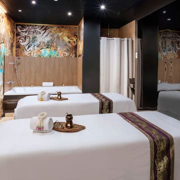a room with beds and shower