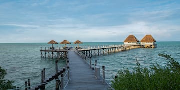 a dock with straw umbrellas on it