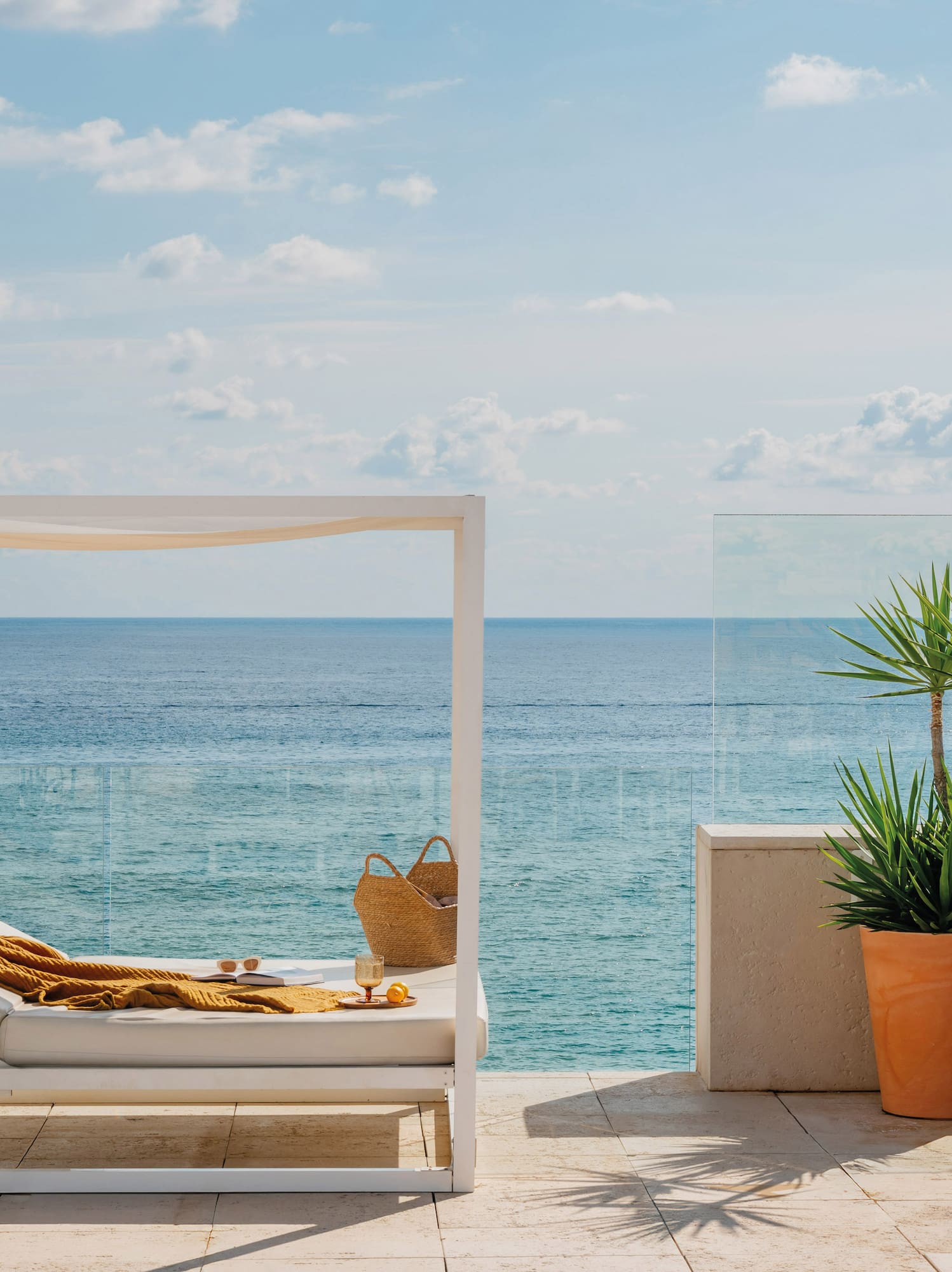 a lounge chair on a deck overlooking the ocean