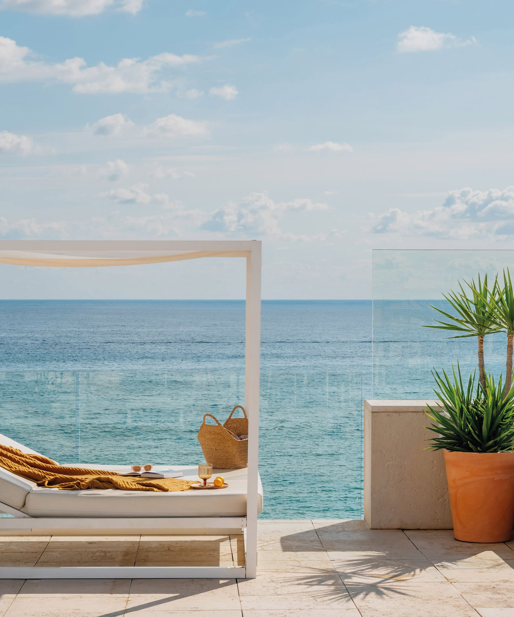 a lounge chair on a deck overlooking the ocean