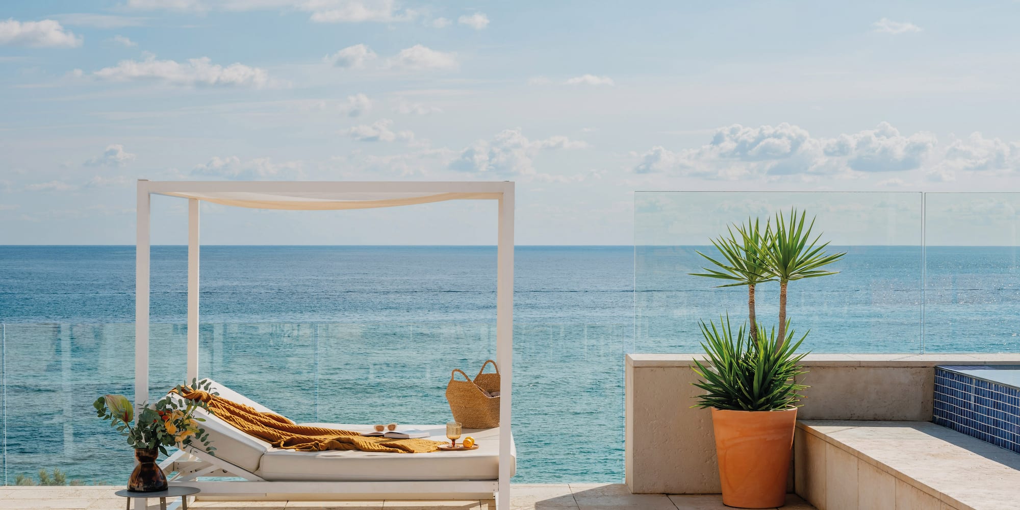 a lounge chair on a deck overlooking the ocean