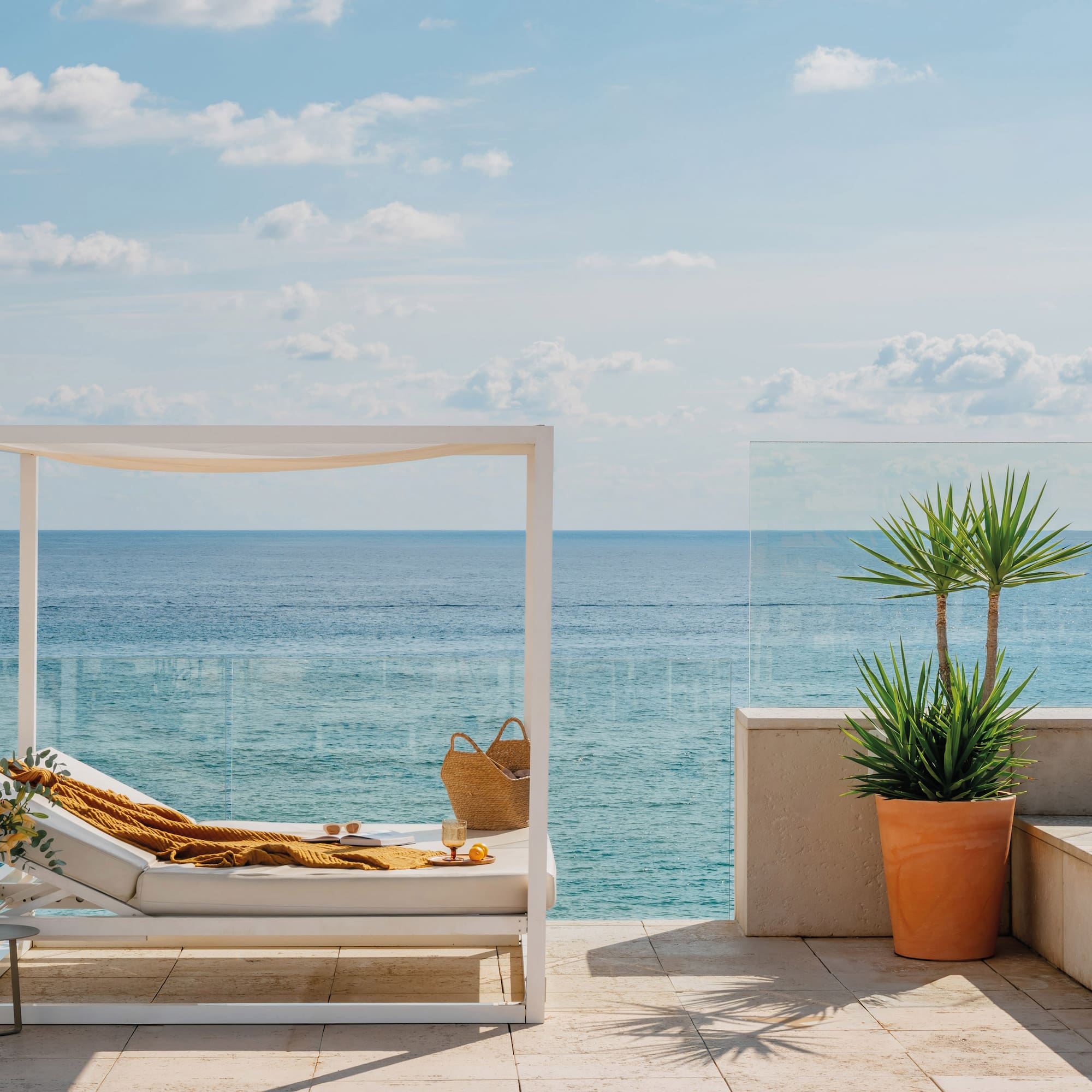 a lounge chair on a deck overlooking the ocean
