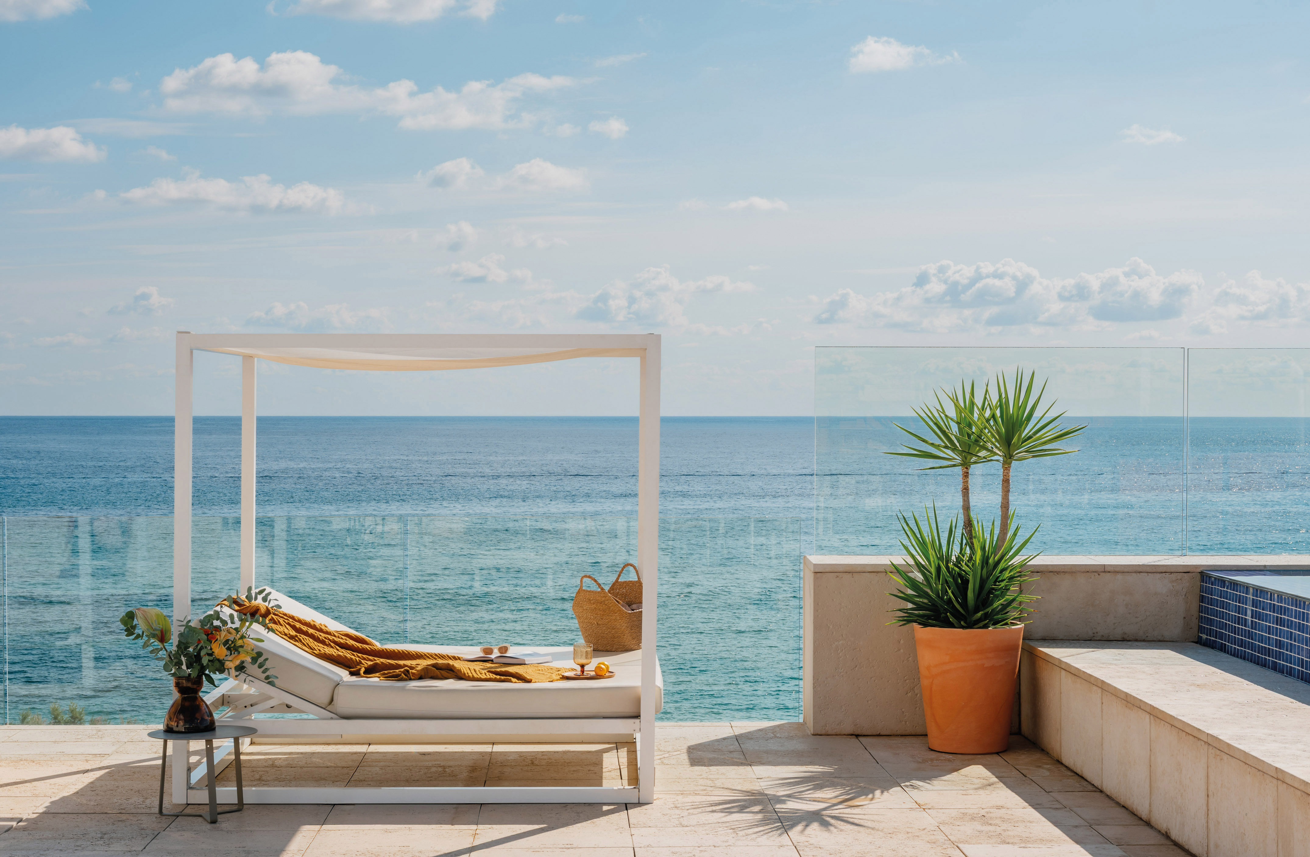 a lounge chair on a deck overlooking the ocean