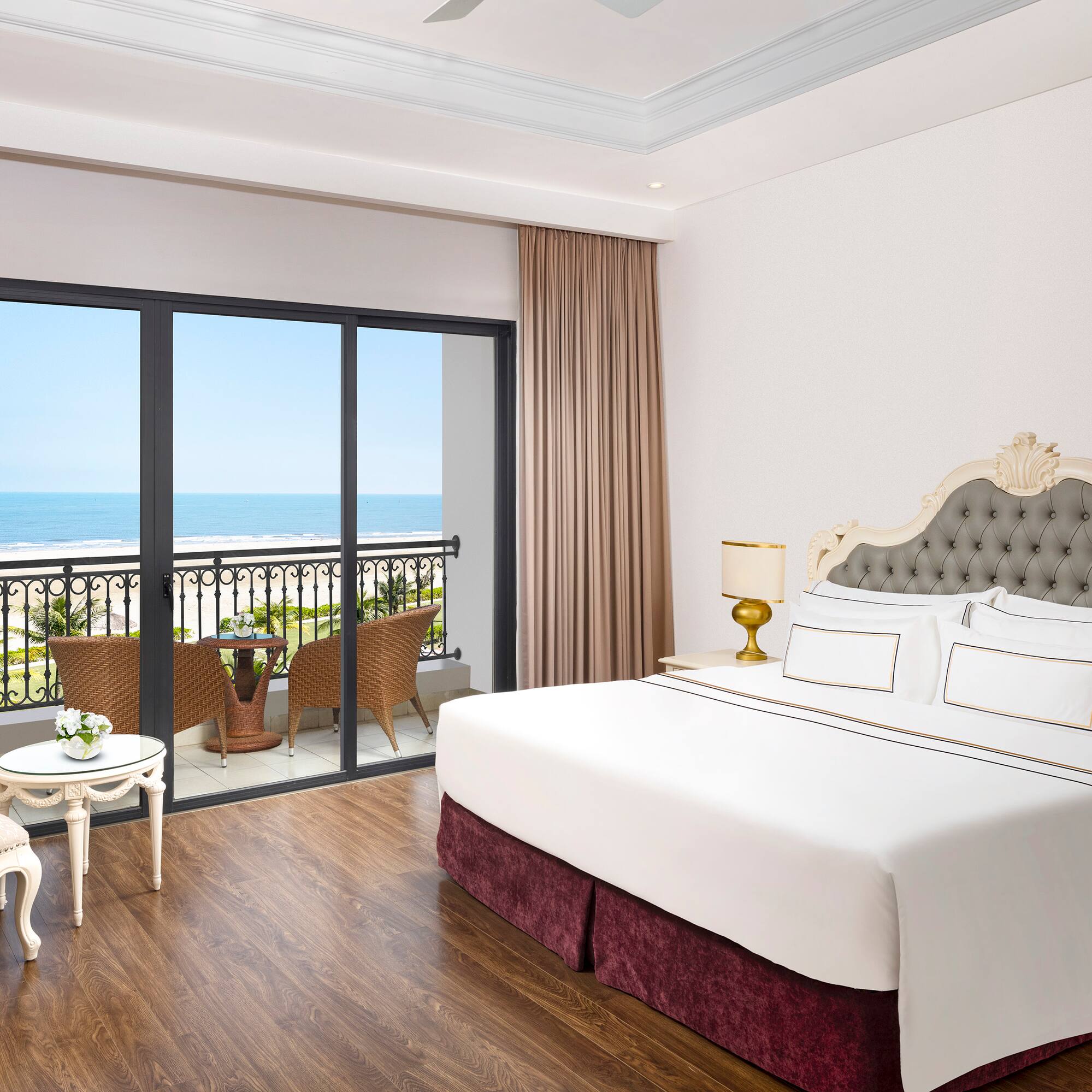 a bedroom with a balcony overlooking the ocean