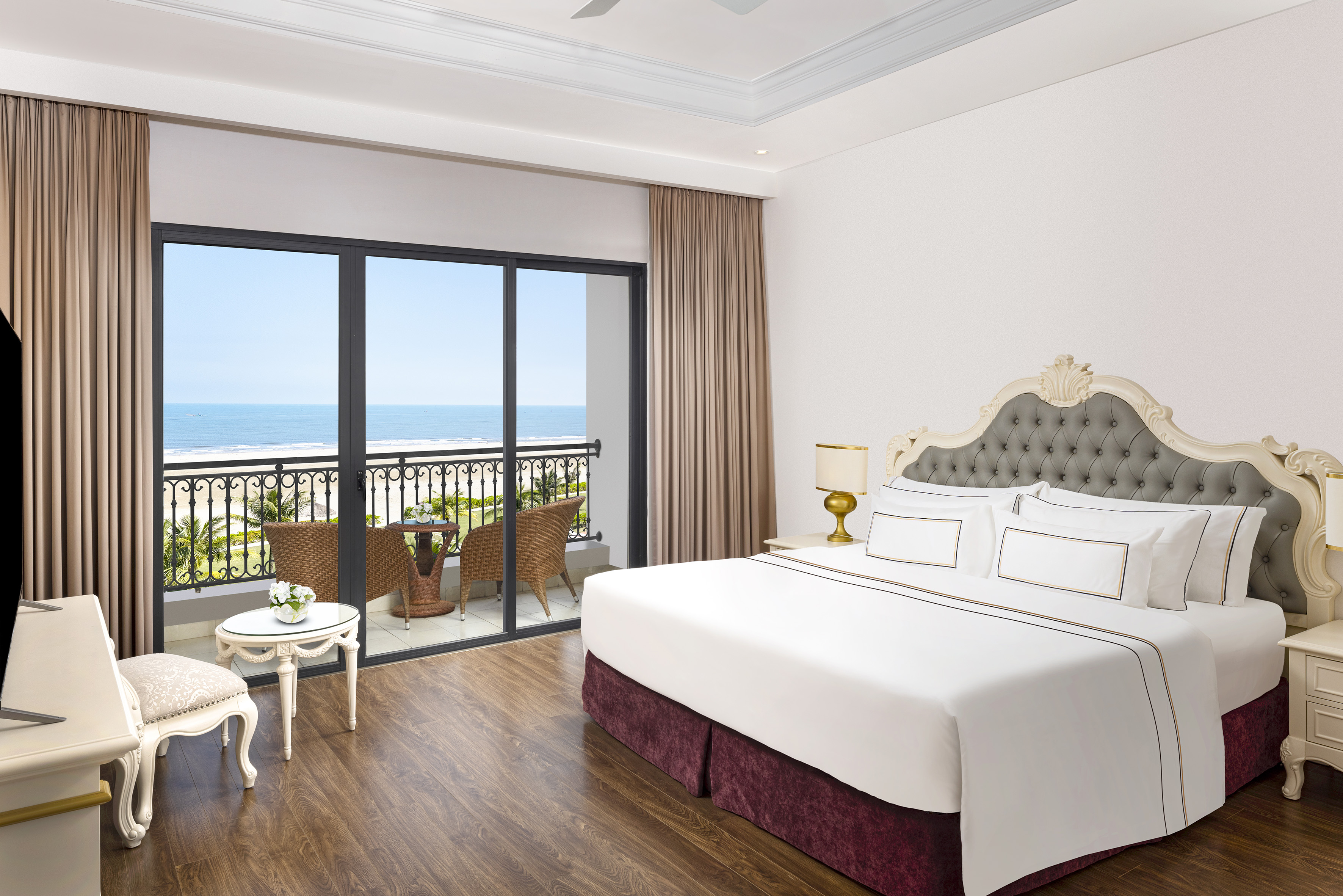 a bedroom with a balcony overlooking the ocean