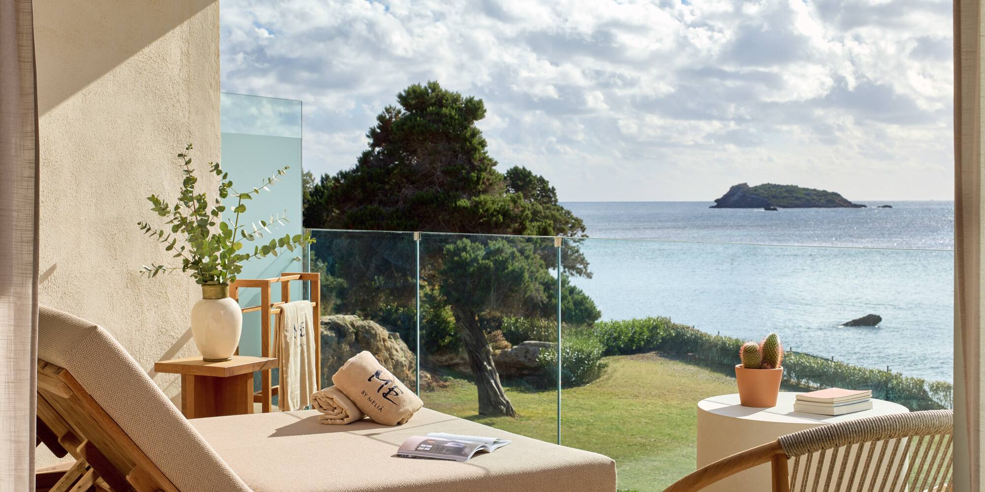 a deck with a view of the ocean and a chair and a table