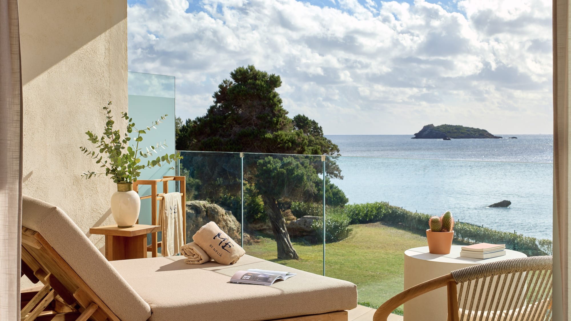 a deck with a view of the ocean and a chair and a table