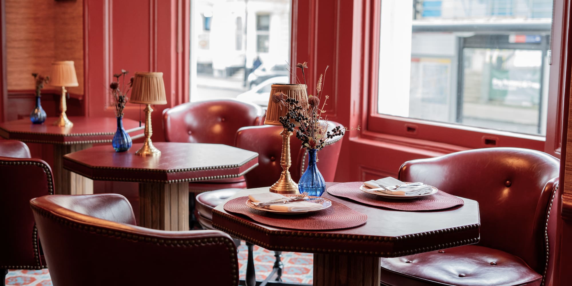 a table with chairs and a vase on it