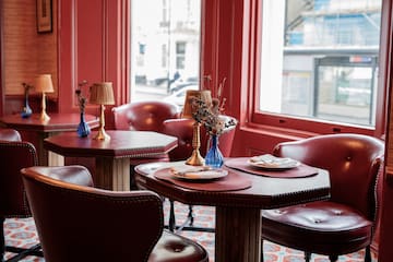 a table with chairs and a vase on it