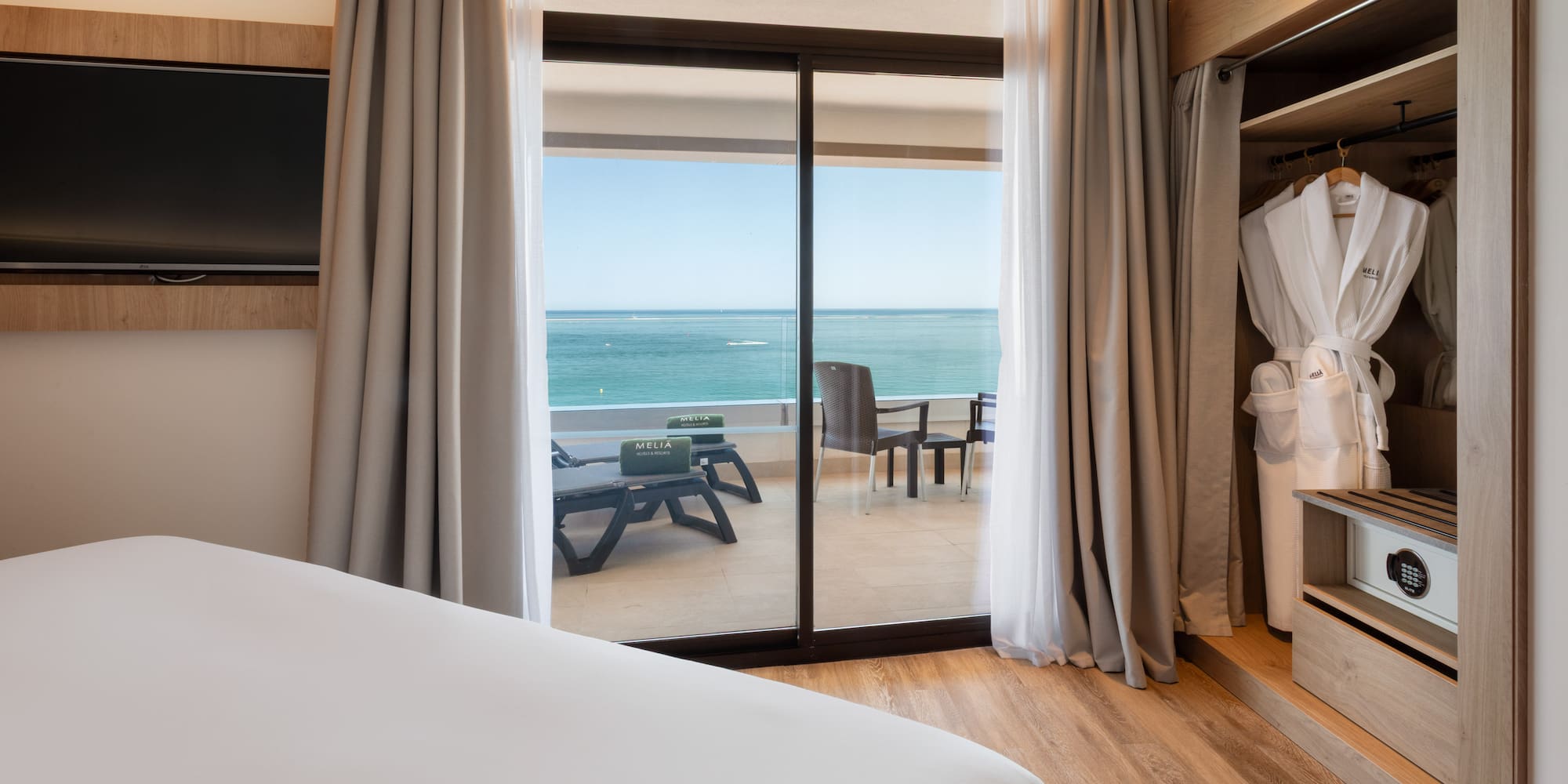 a room with a bed and a sliding glass door