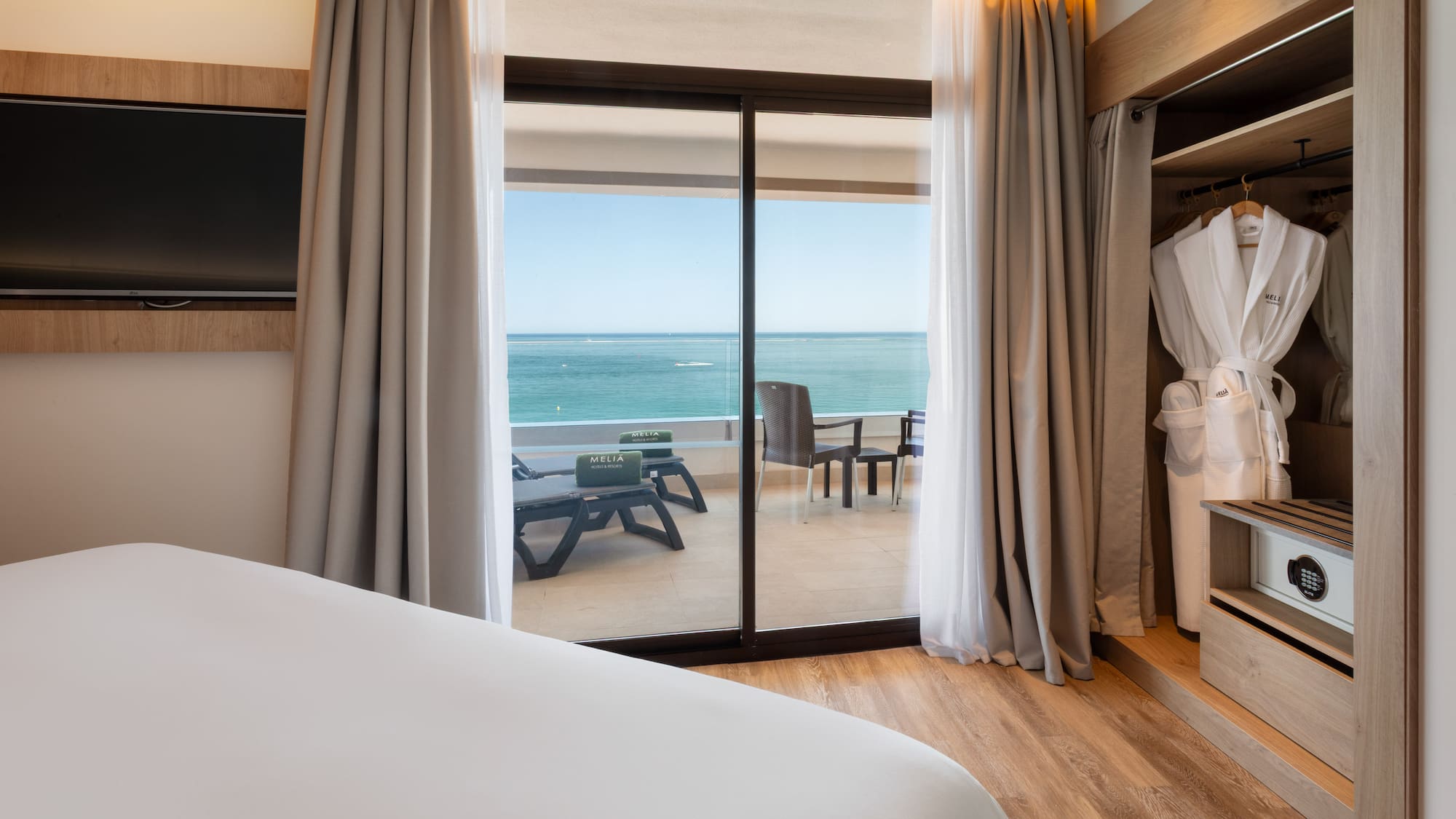 a room with a bed and a sliding glass door