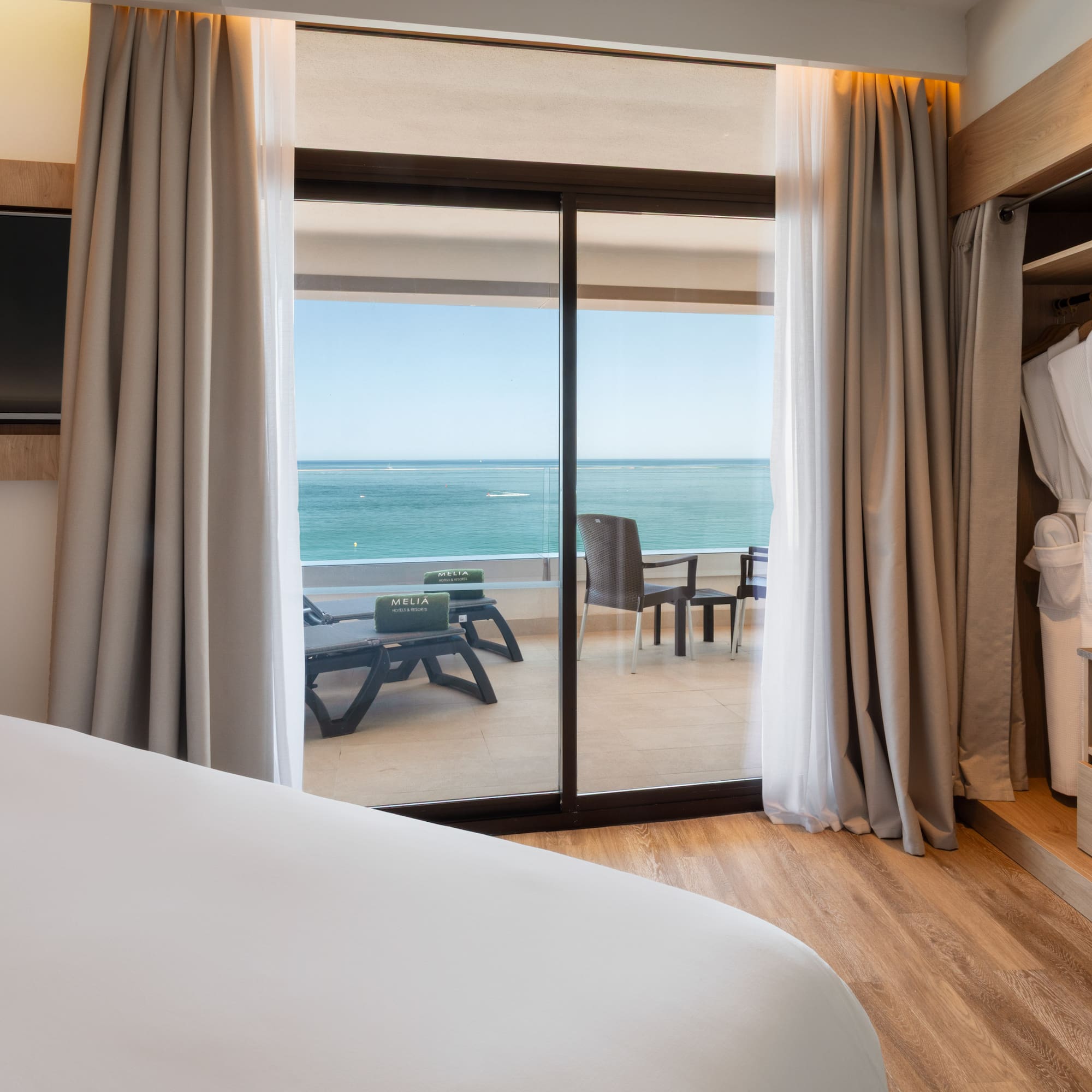 a room with a bed and a sliding glass door