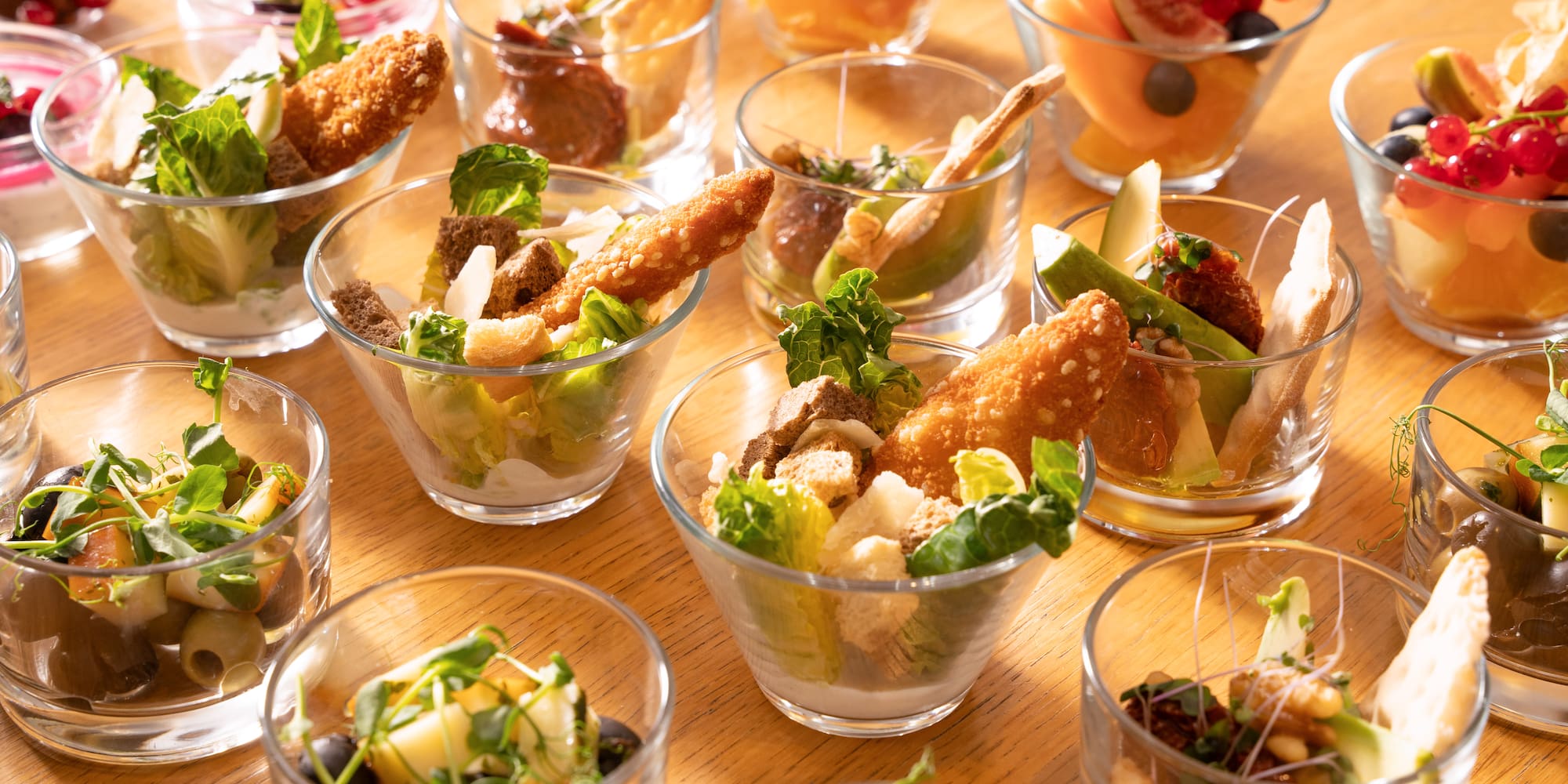 a table full of small glasses of food