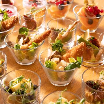 a table full of small glasses of food