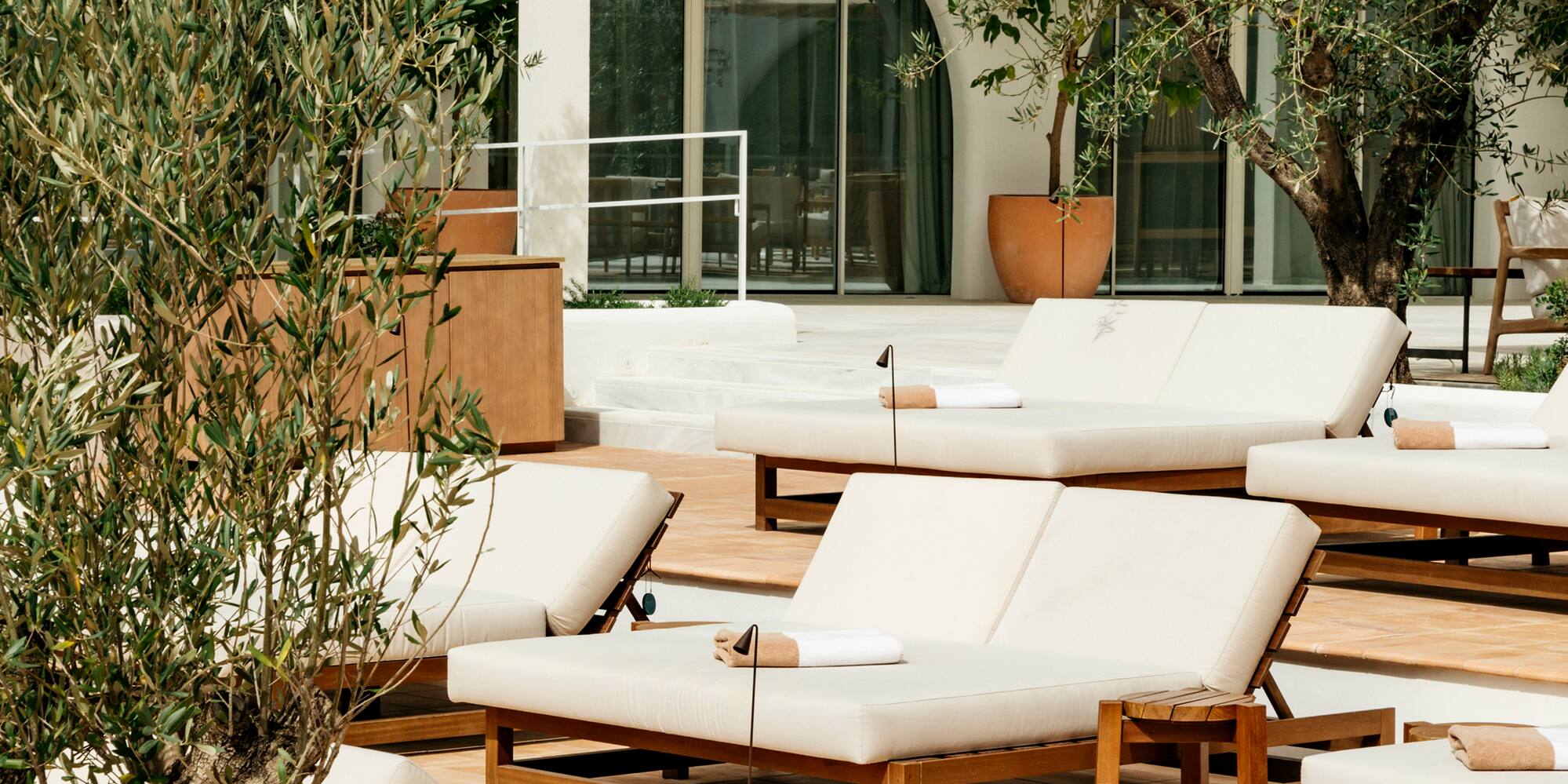 a group of lounge chairs outside of a building