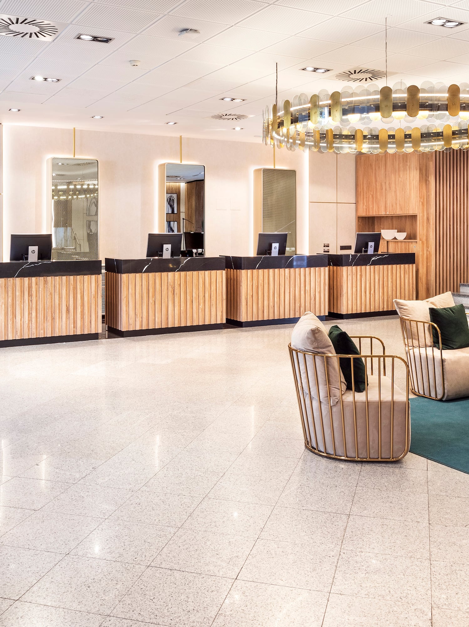 a lobby with a chandelier and chairs