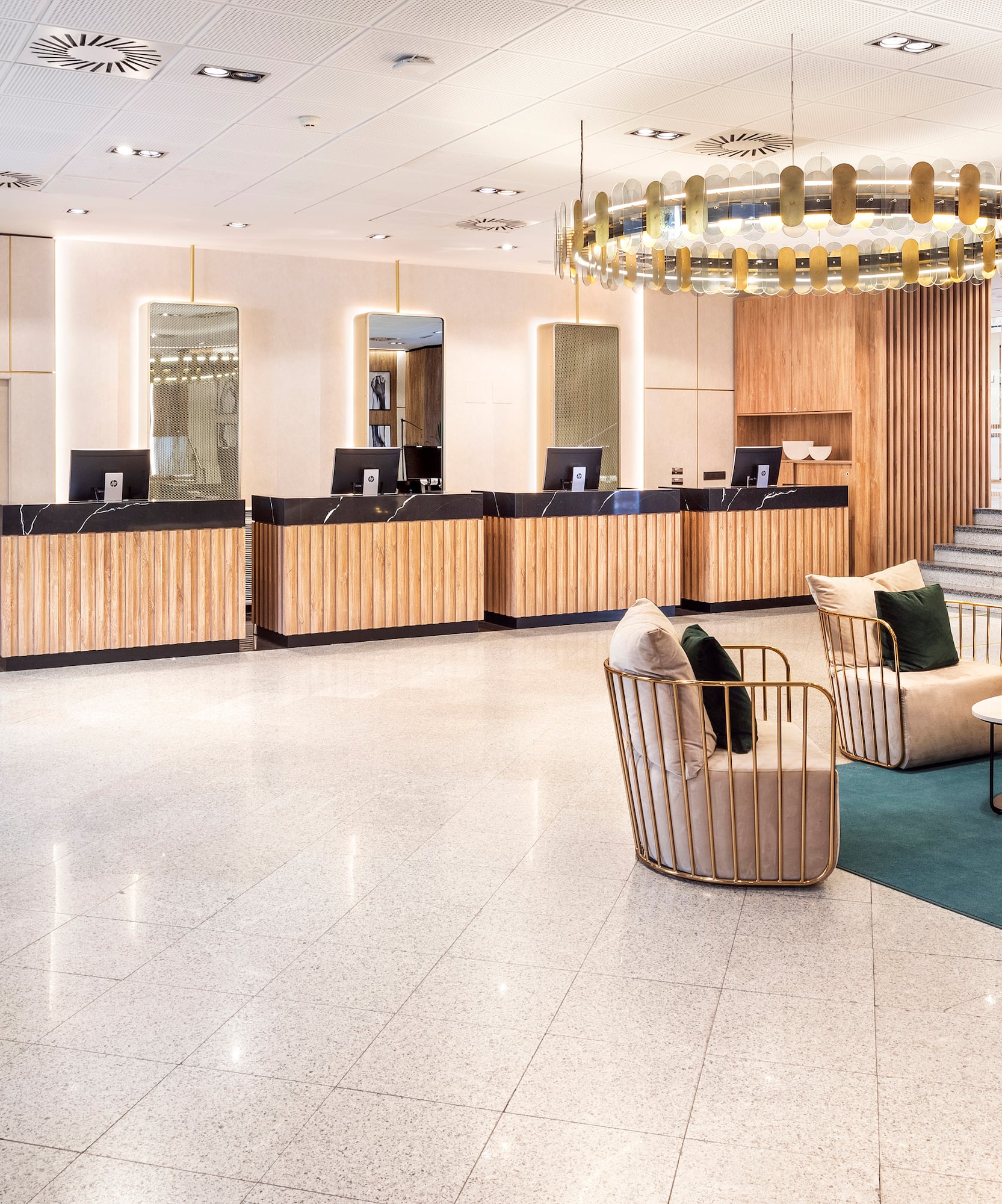 a lobby with a chandelier and chairs