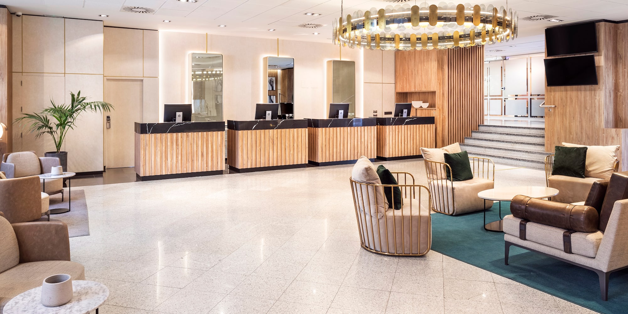 a lobby with a chandelier and chairs.