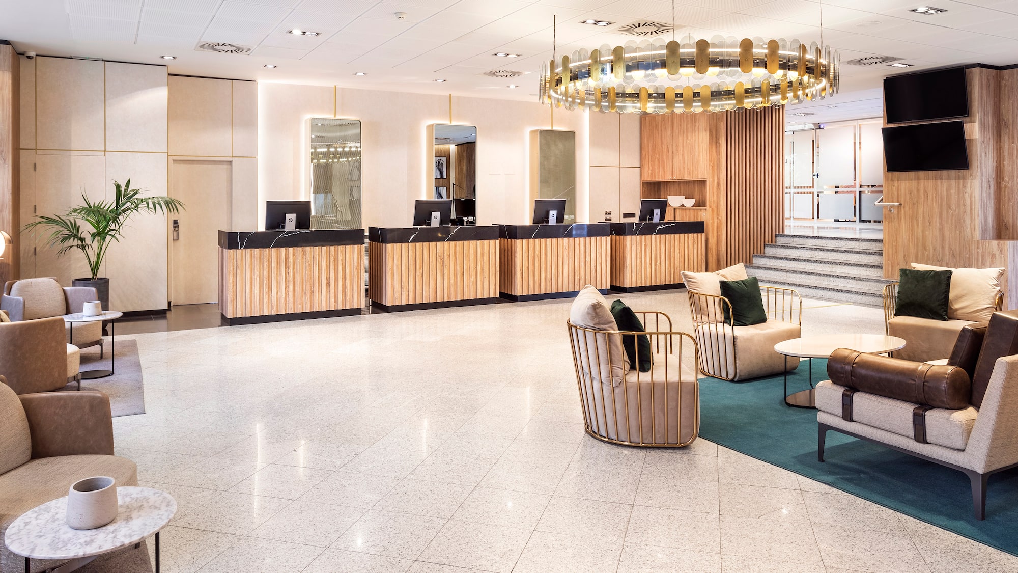 a lobby with a chandelier and chairs