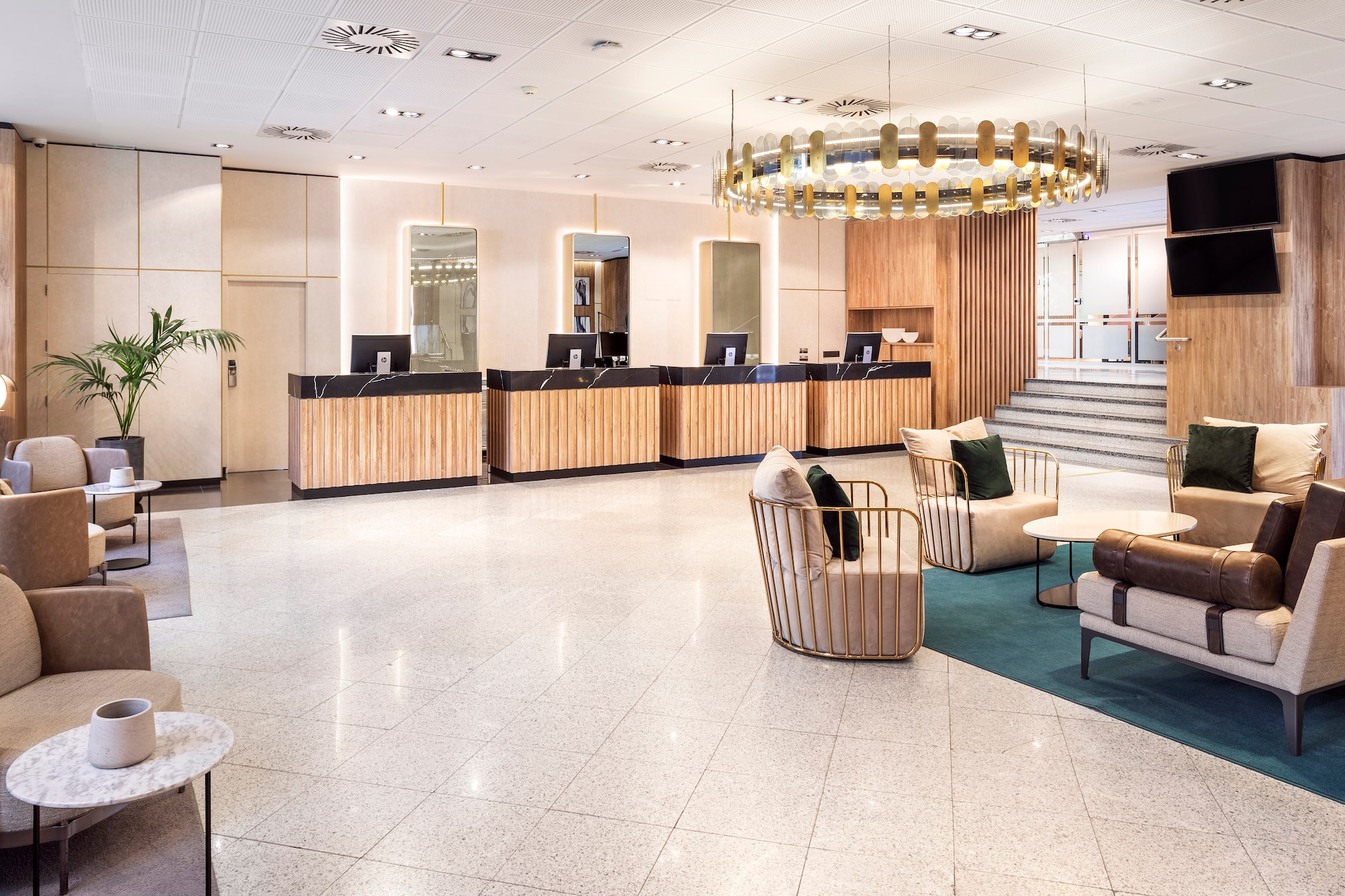 a lobby with a chandelier and chairs