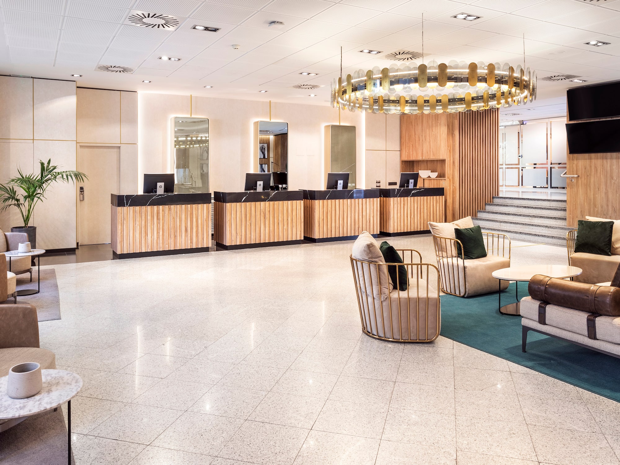 a lobby with a chandelier and chairs.