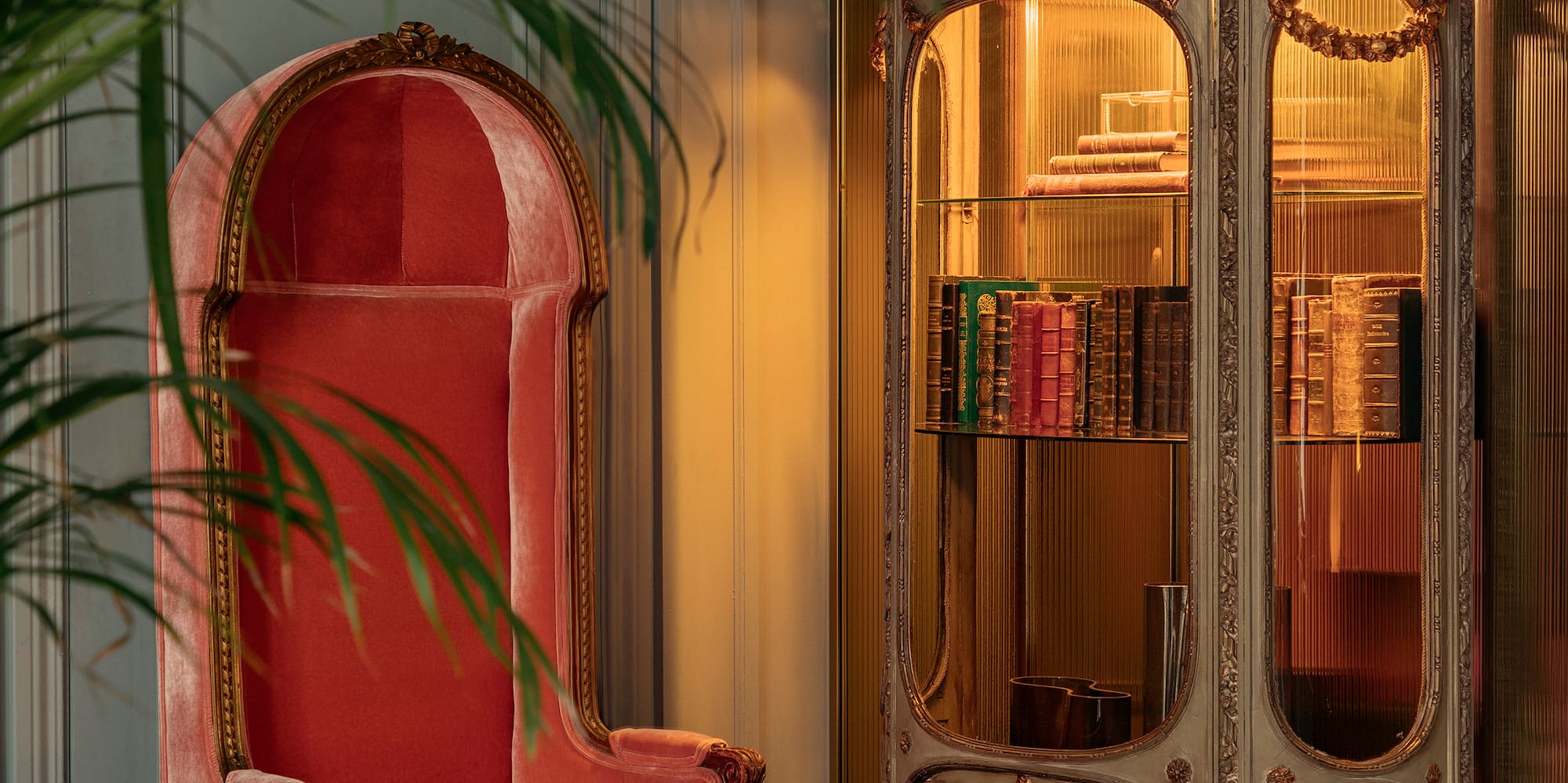 a chair next to a glass cabinet