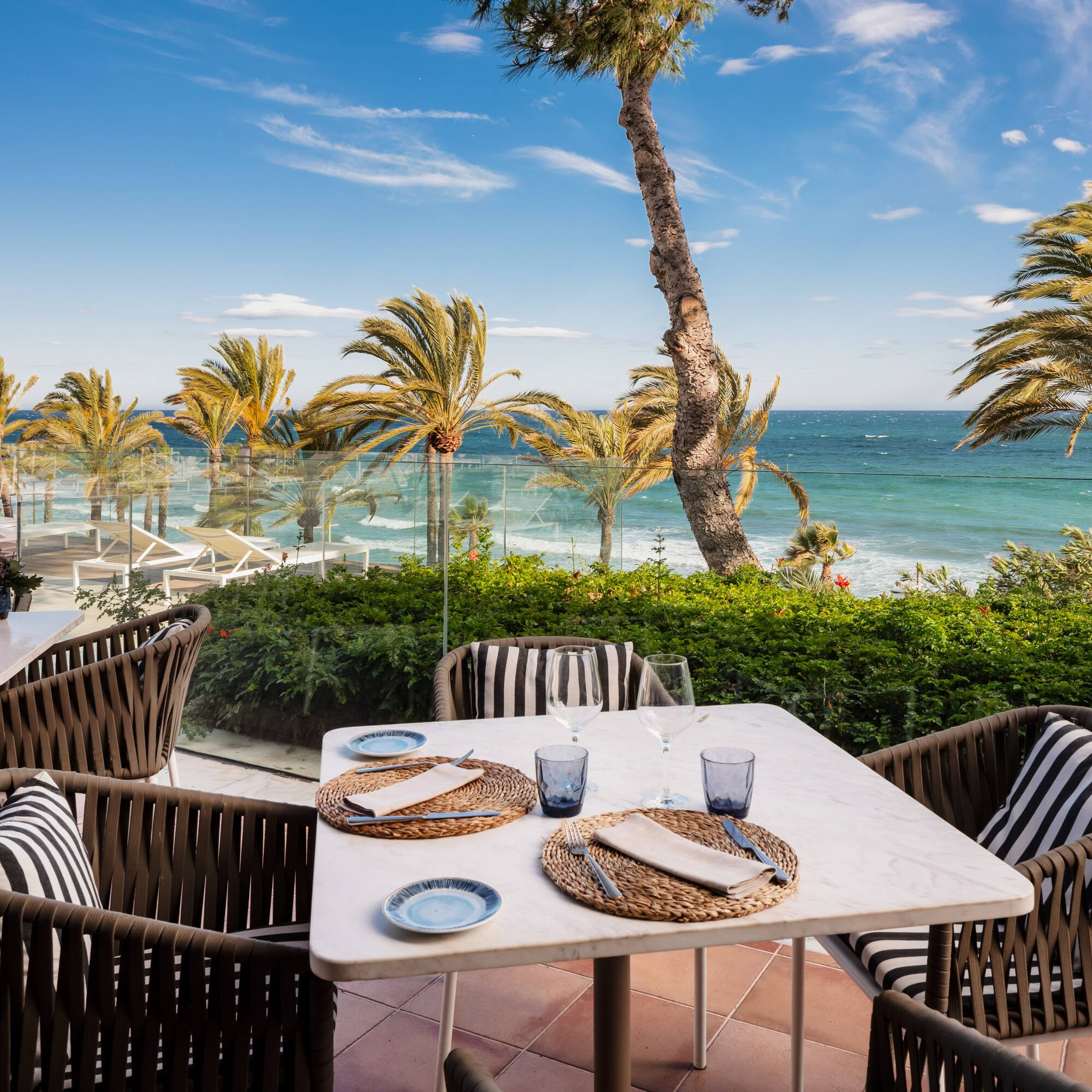a beach with palm trees and a body of water