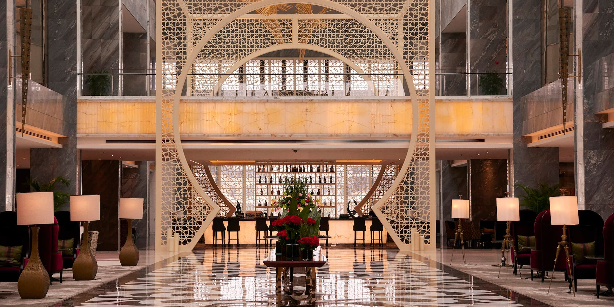 a large room with a large screen and a large table with flowers