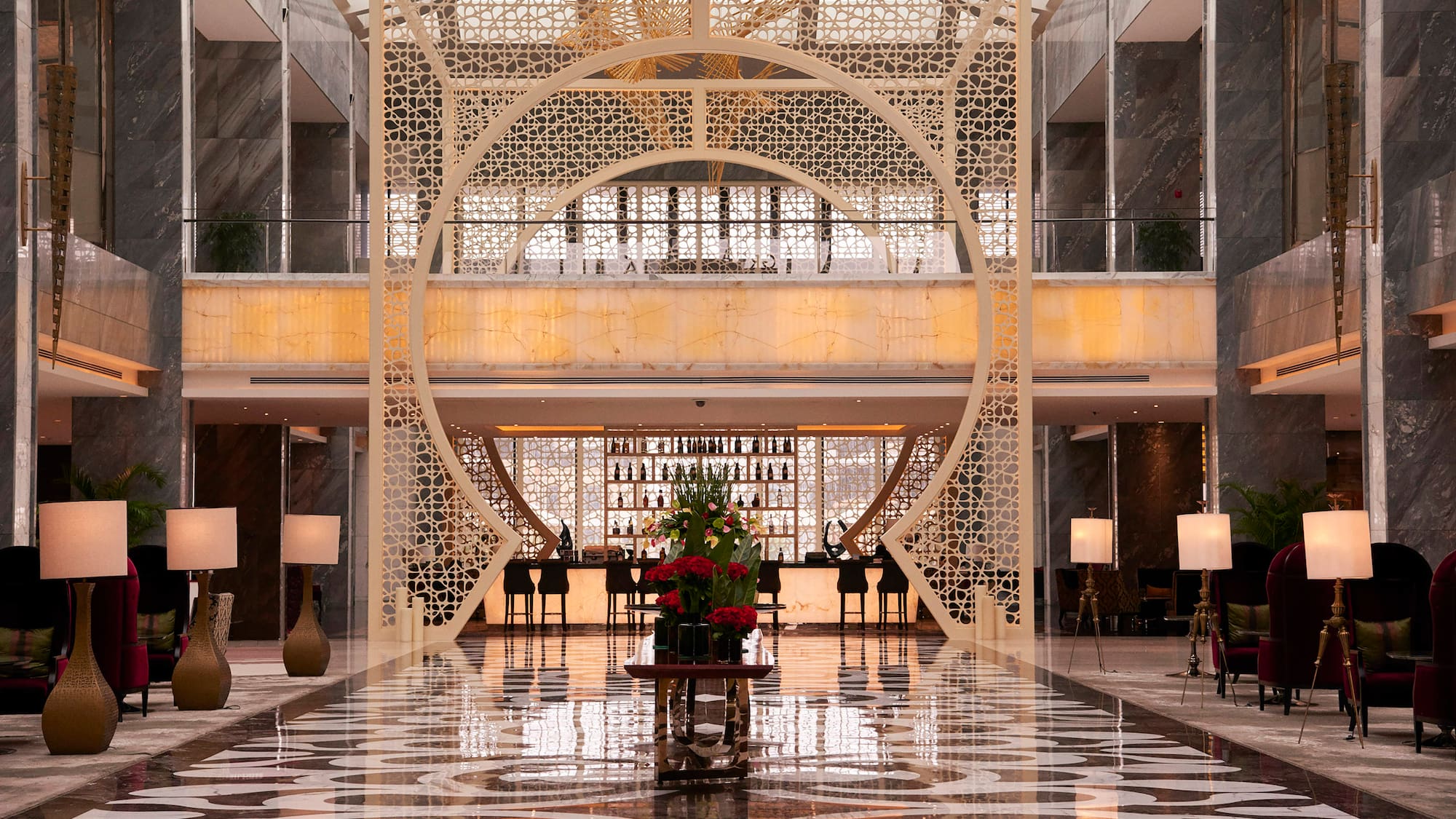 a large room with a large screen and a large table with flowers