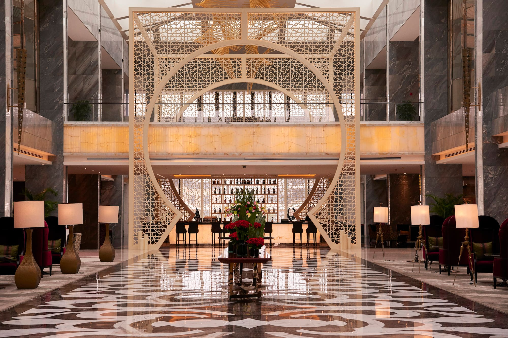 a large room with a large screen and a large table with flowers