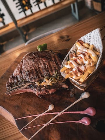 a steak and fries on a wooden table