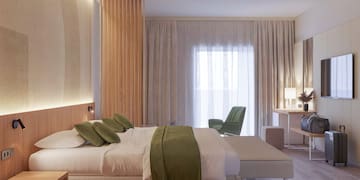 a bedroom with a bed and a chair