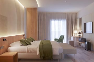 a bedroom with a bed and a chair