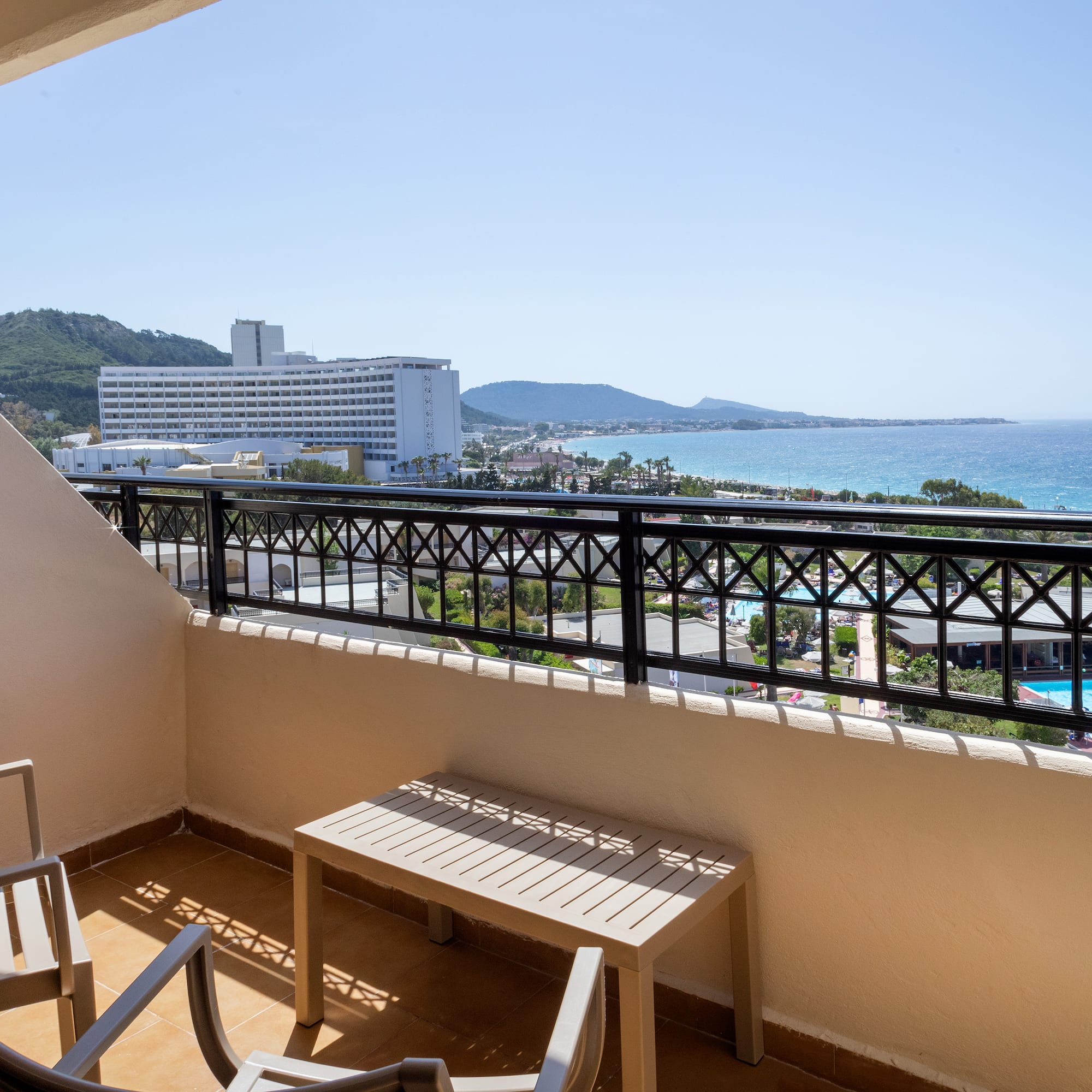a balcony with chairs and a view of the ocean