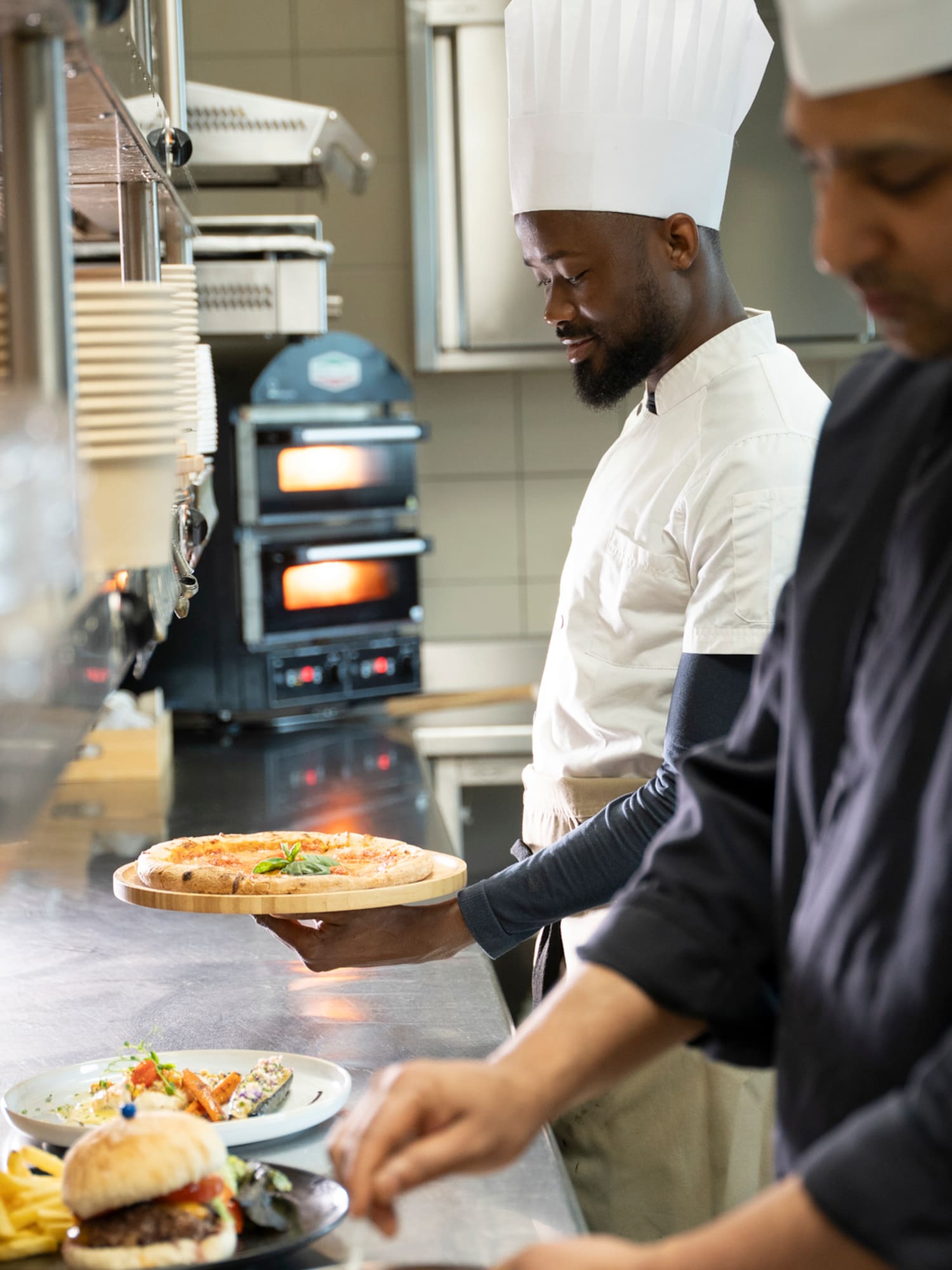a chef holding a pizza