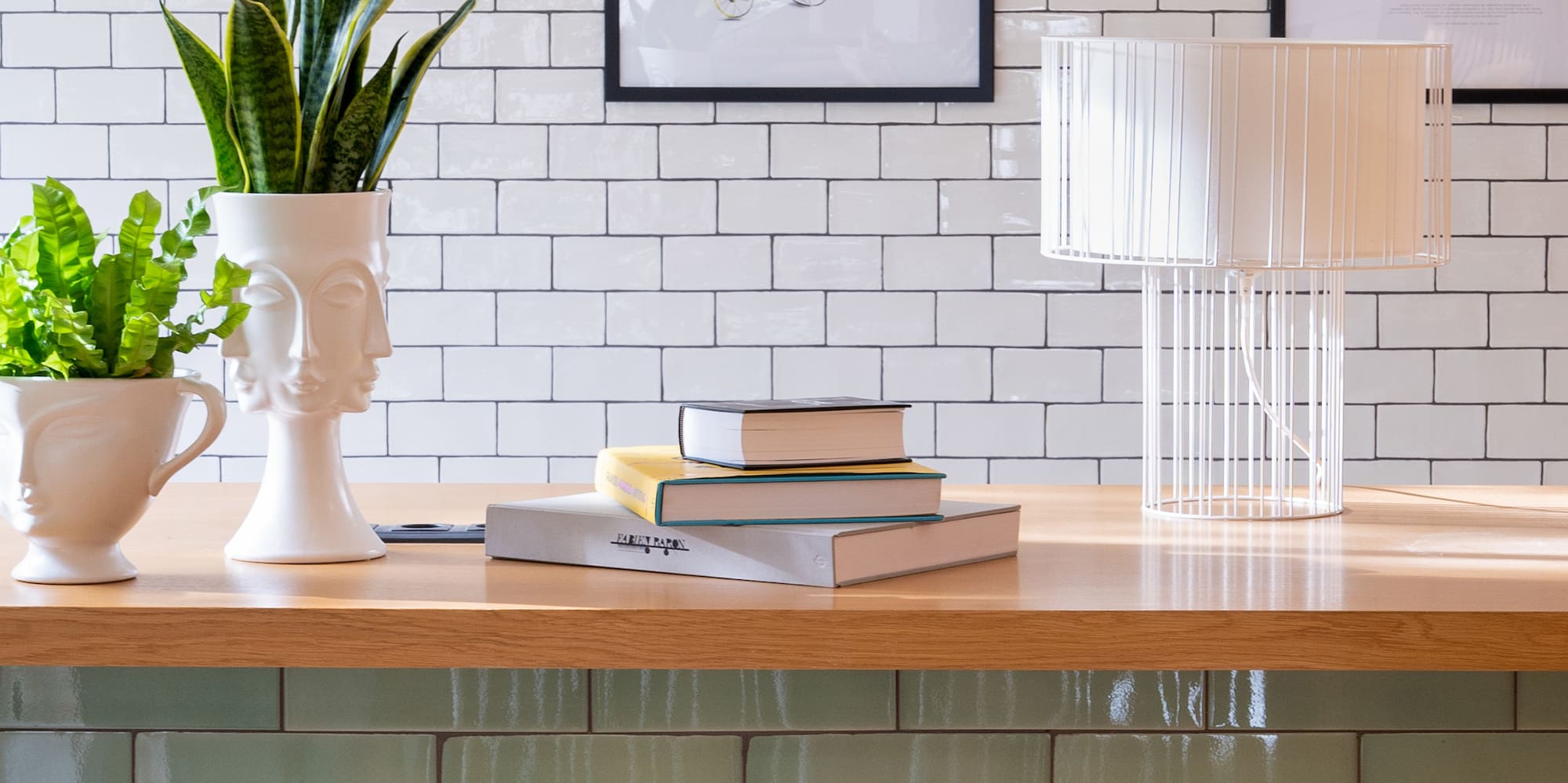 a table with white chairs and a lamp and vases on it