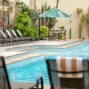 a pool with chairs and umbrellas