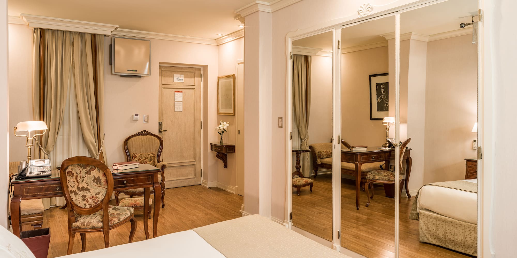 a room with a mirror wall and a bed