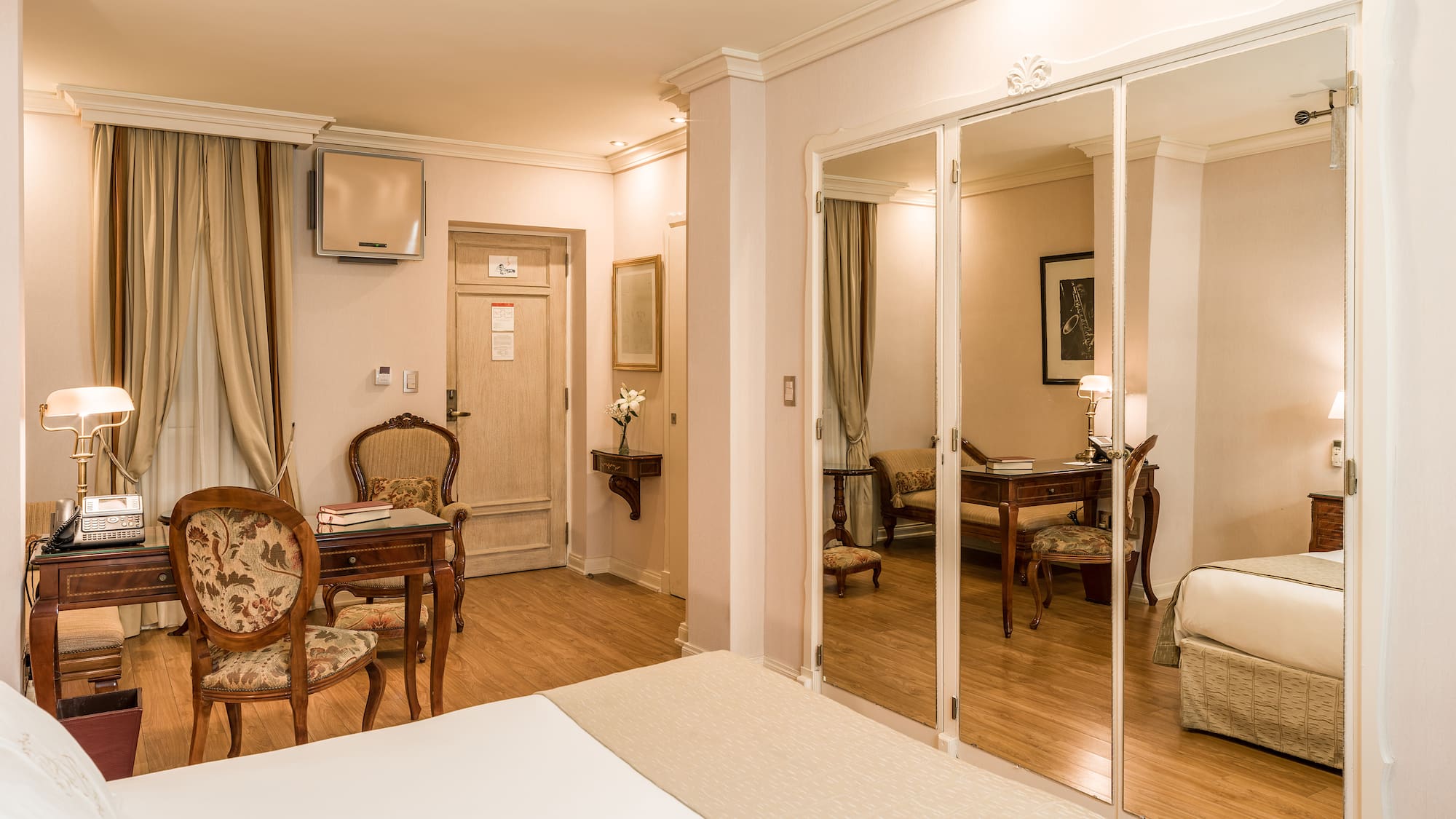 a room with a mirror wall and a bed