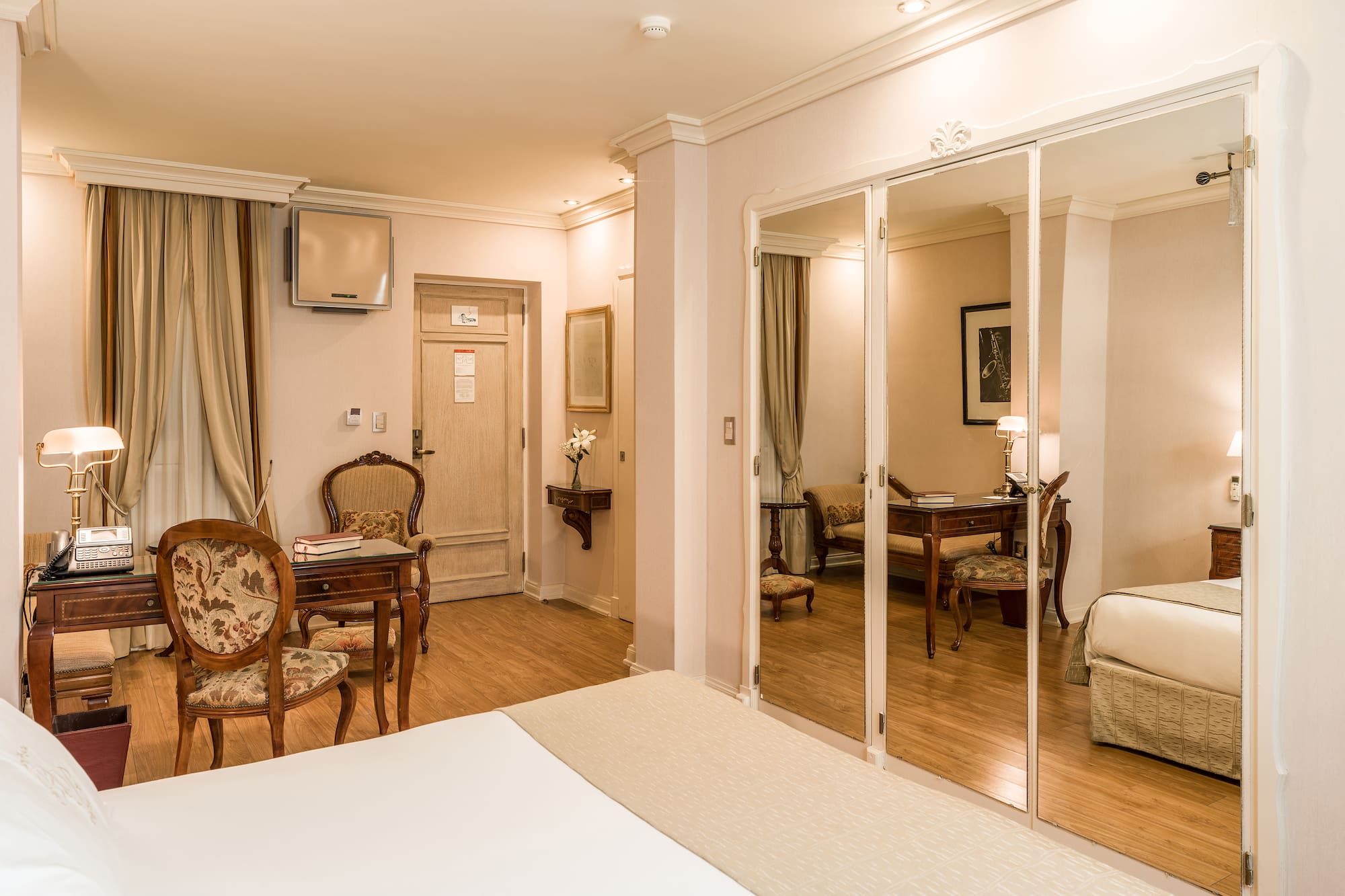 a room with a mirror wall and a bed