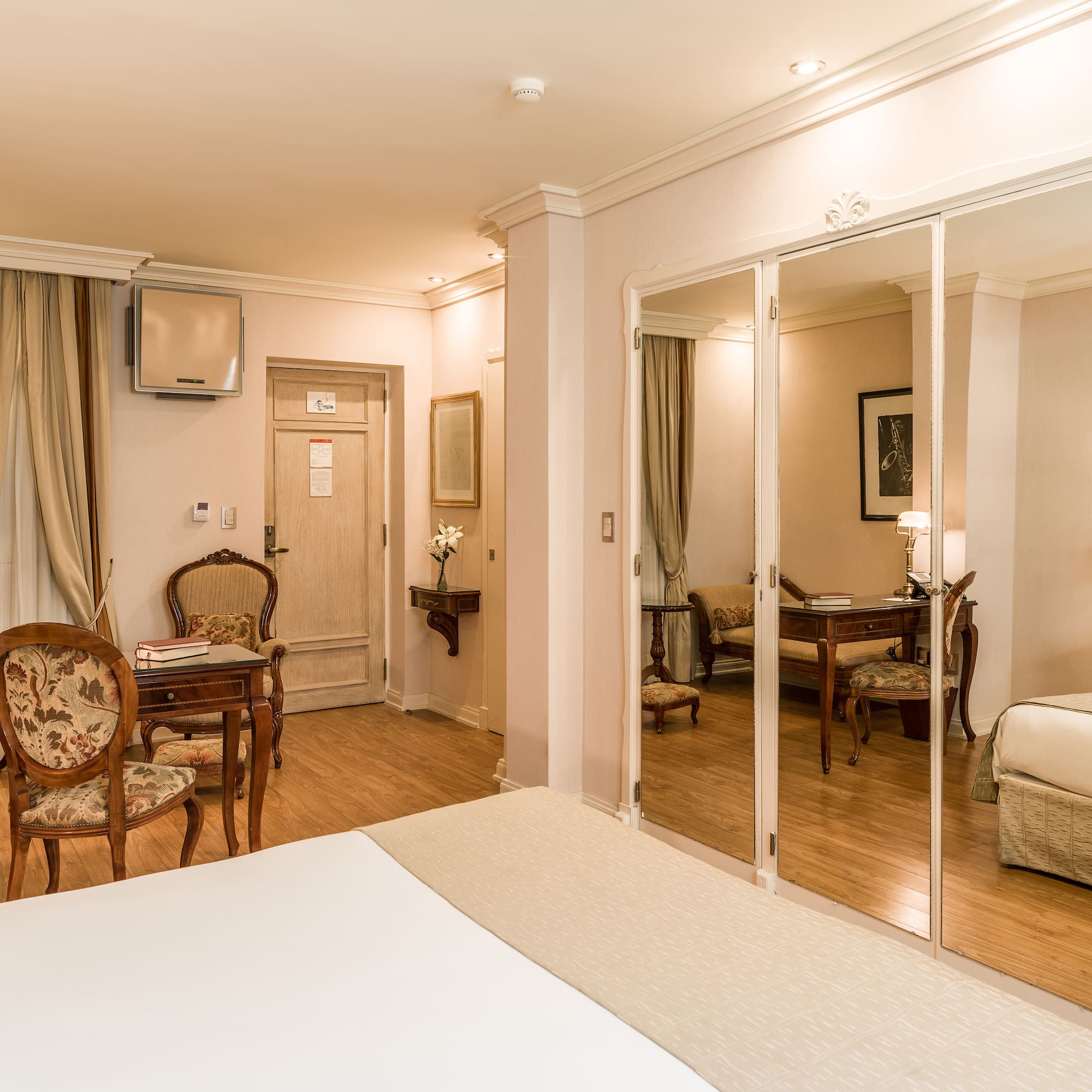 a room with a mirror wall and a bed