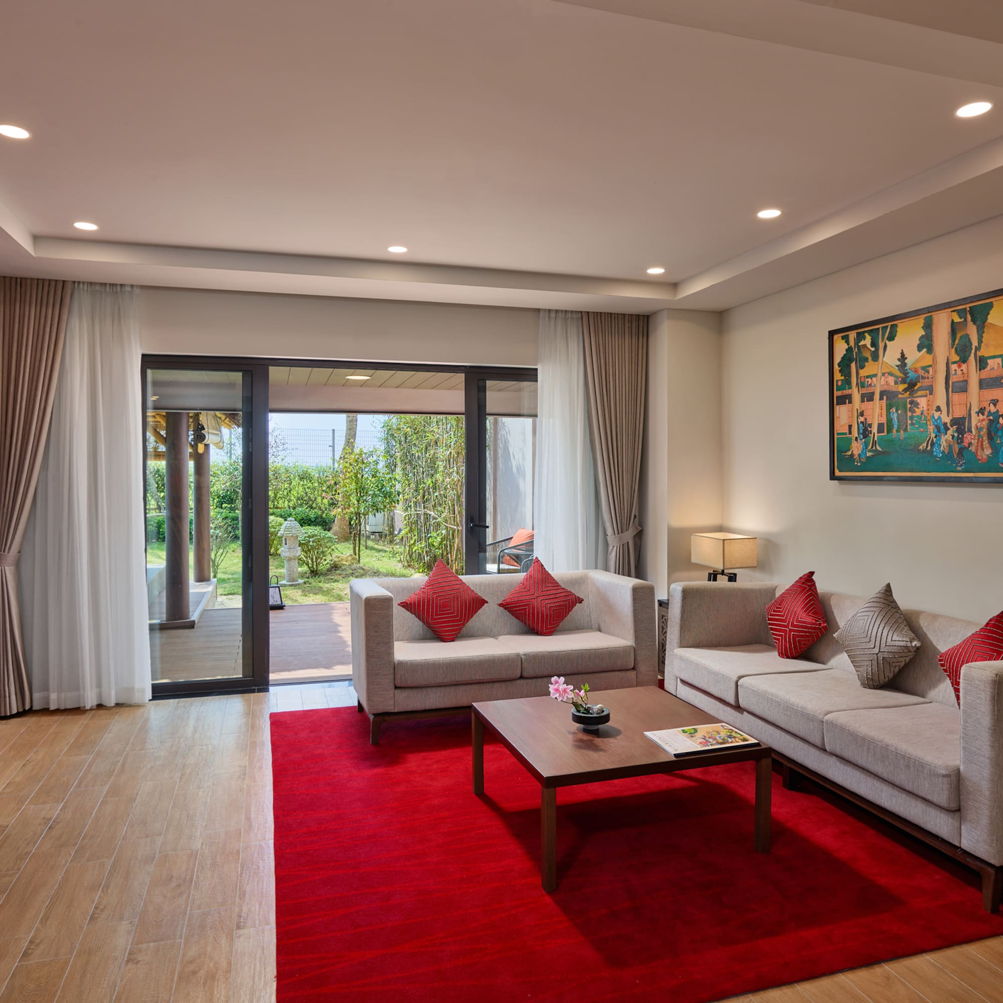 a living room with a red rug and couches