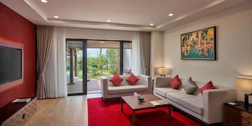 a living room with a red rug and couches