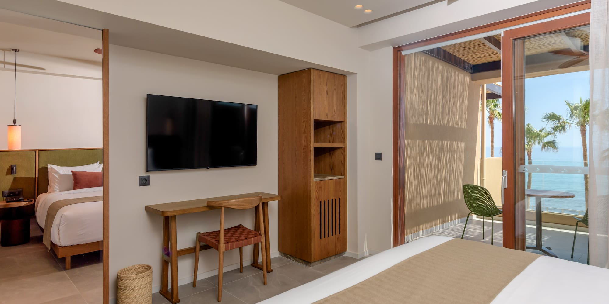 a room with a bed and a television on the wall.