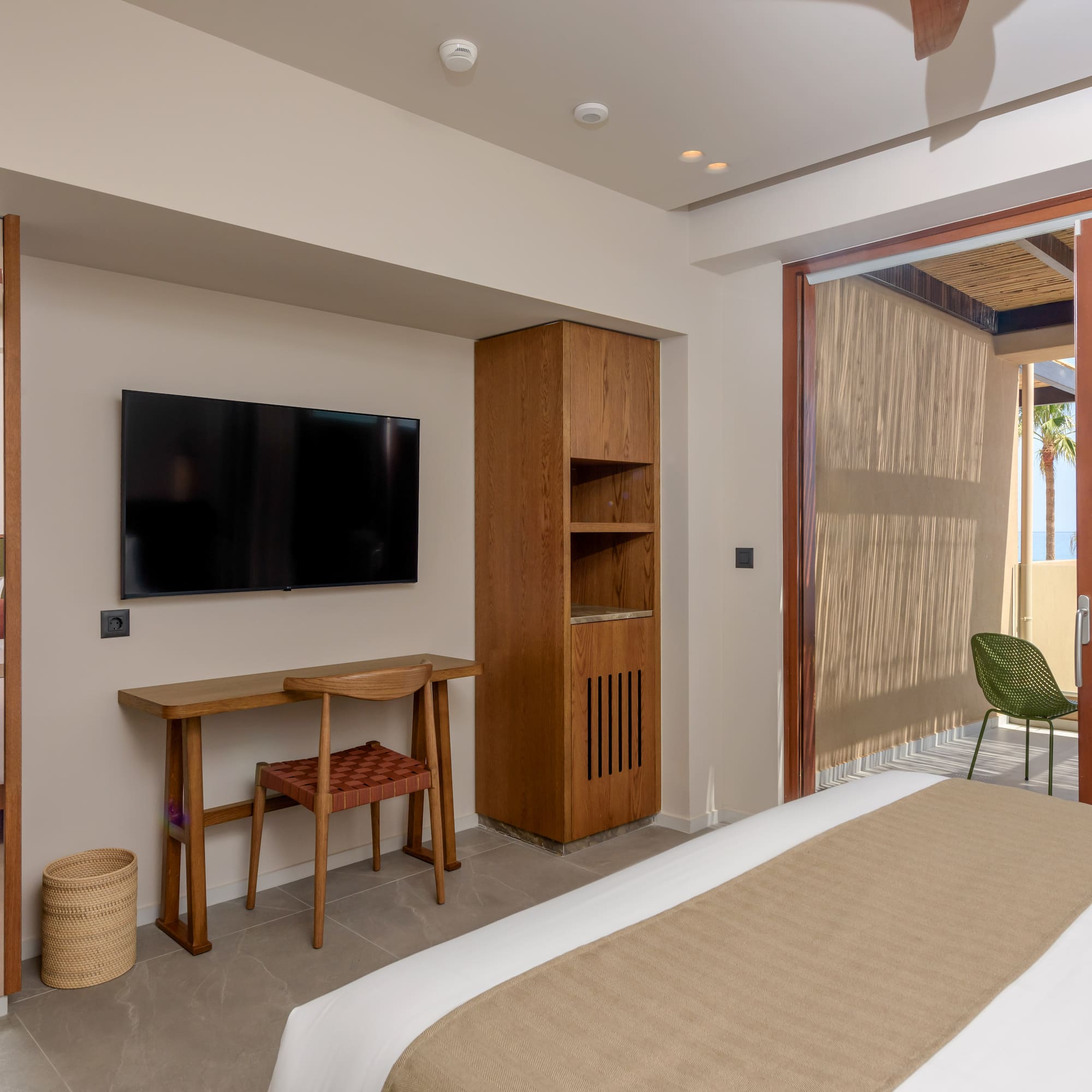 a room with a bed and a television on the wall.