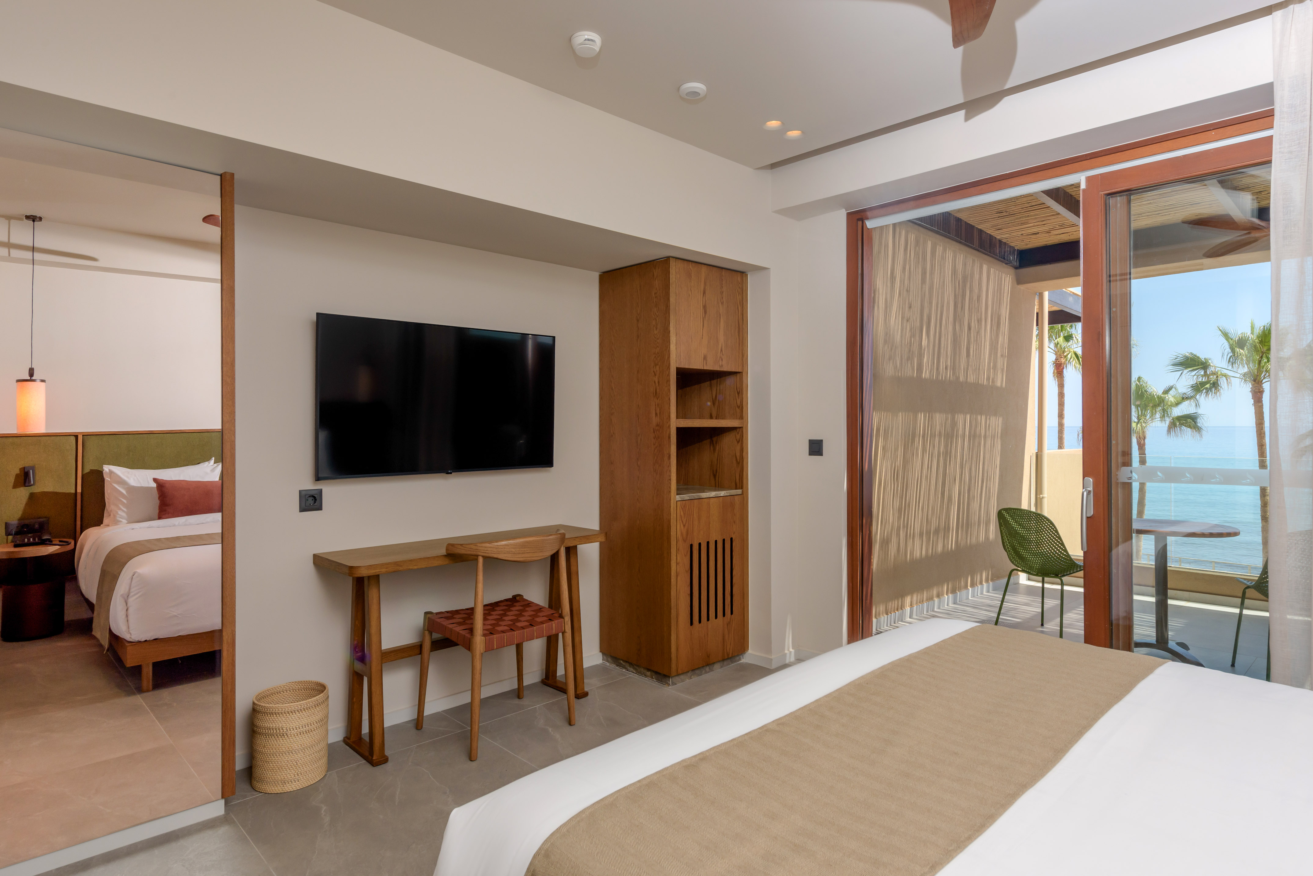 a room with a bed and a television on the wall.