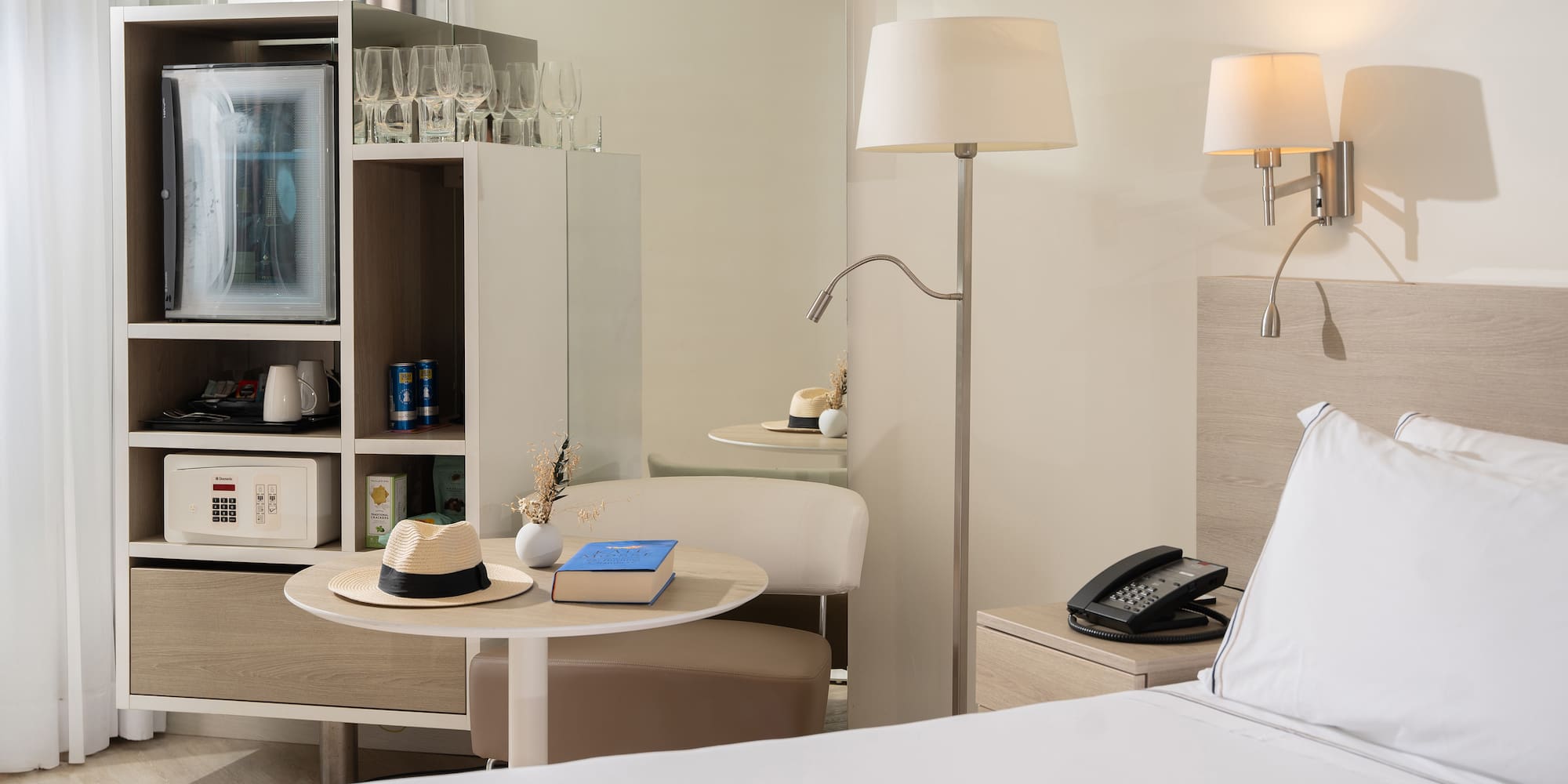 a room with a bed and a table and a television